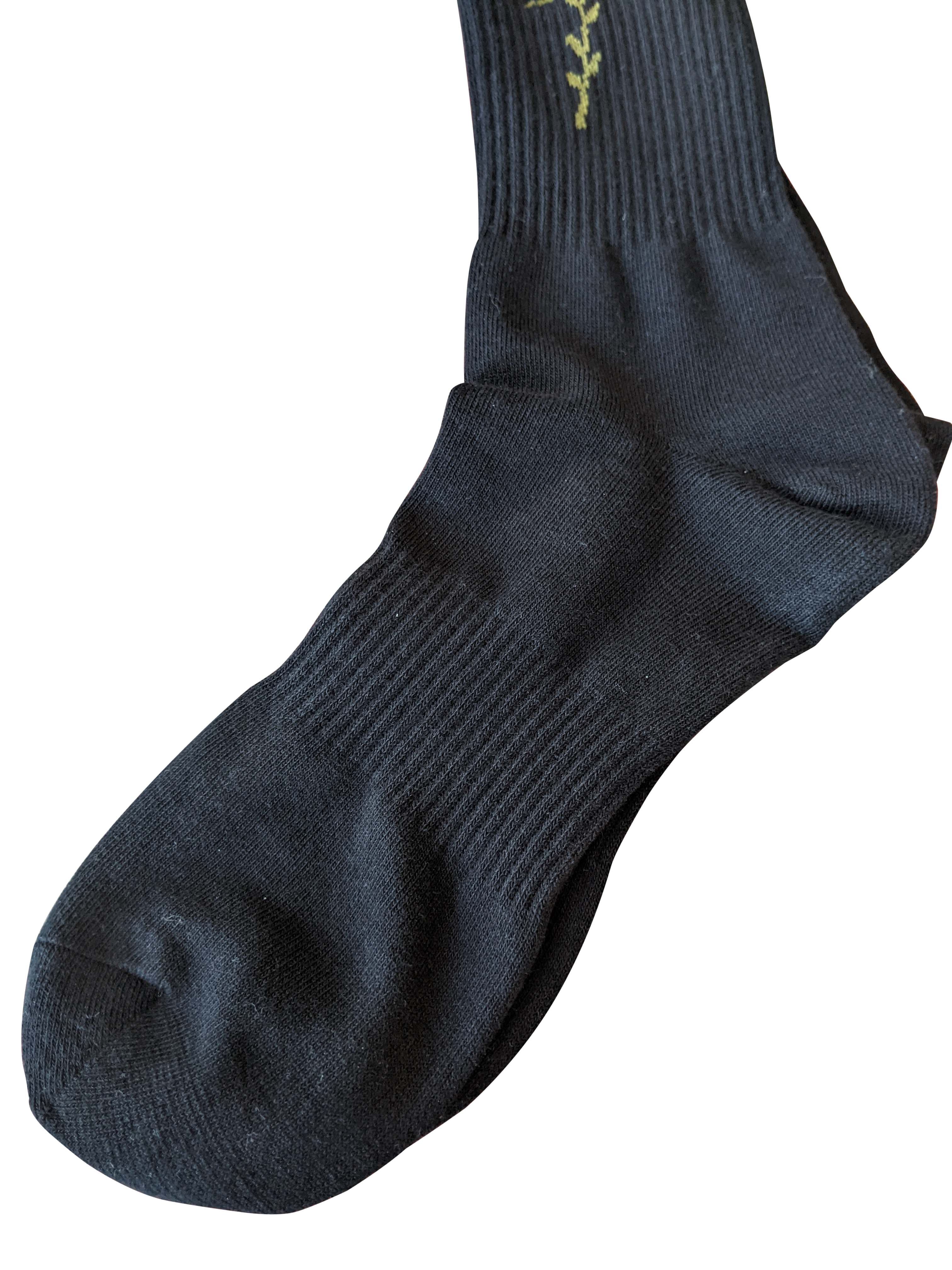 Black ribbed knit sport sock with olive green embroidered vine near the cuff from 4 rth collection