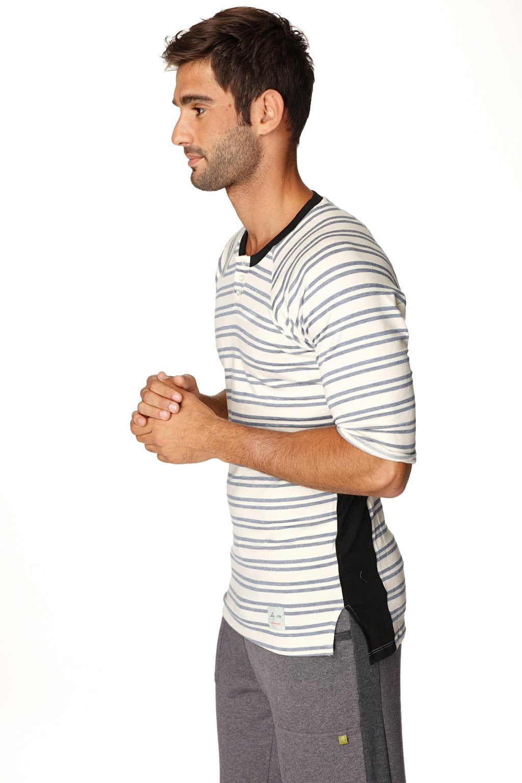 A man wearing a cool blue stripe 4-rth mens vintage-stripe henley tee in french terry loop with black trim