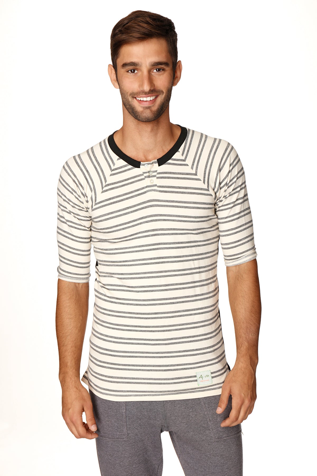 A man wearing a 4-rth mens vintage-stripe henley tee in cream and gray French terry loop with black ribbed collar