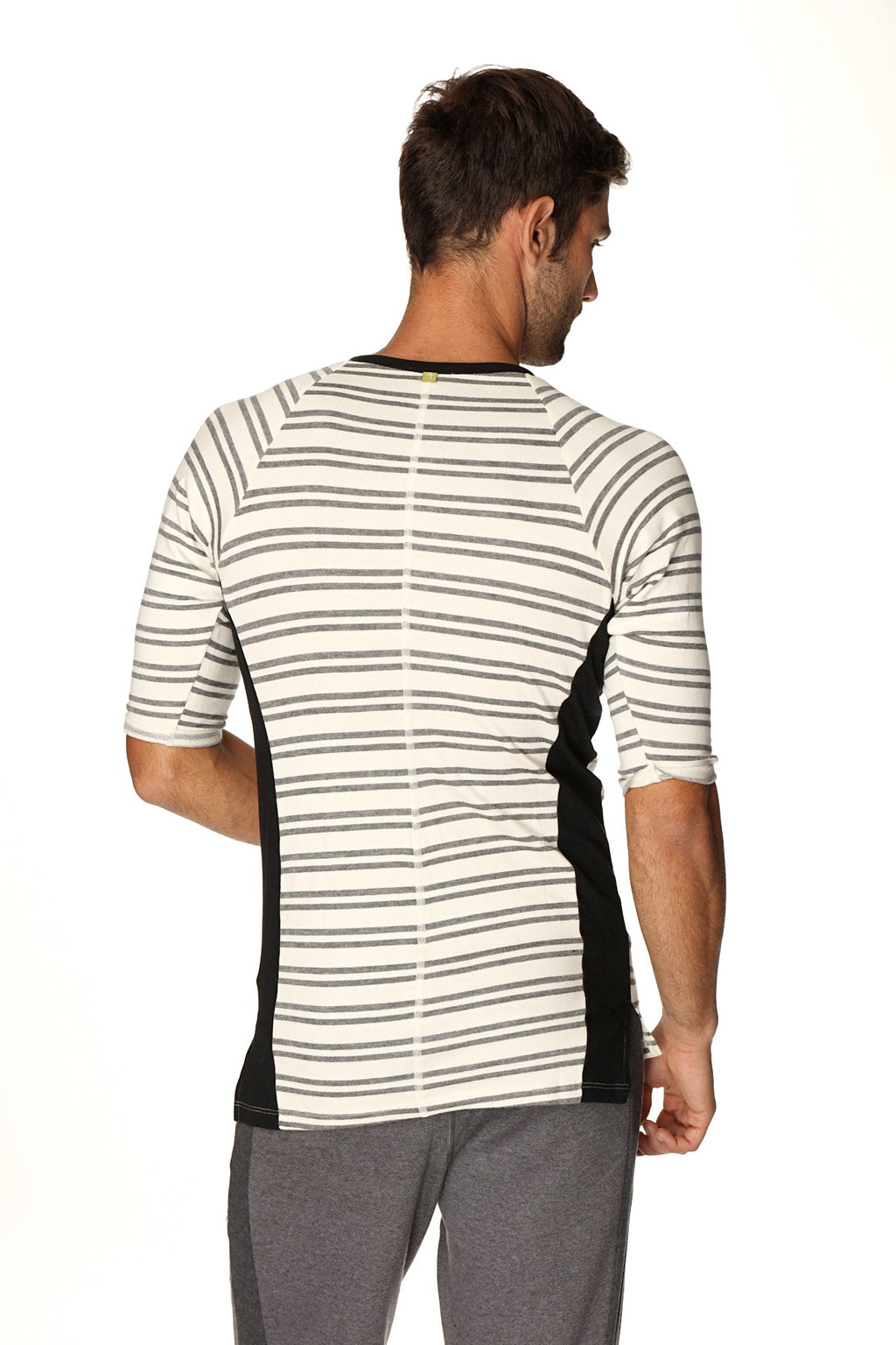 A men’s short-sleeved 4-rth vintage-stripe henley tee in dark grey double stripe french terry loop with black panels and green button