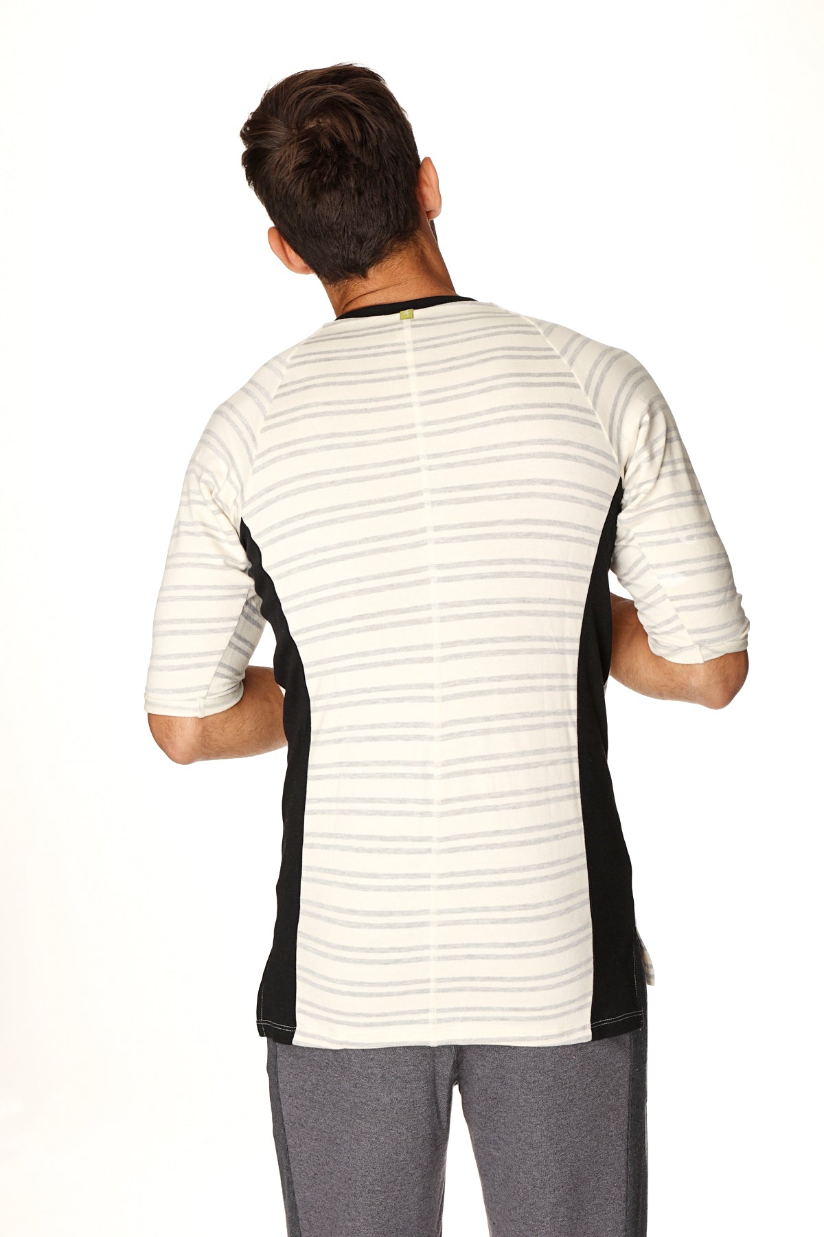 A men’s short-sleeved athletic henley tee in french terry with white base gray stripes and black side panels