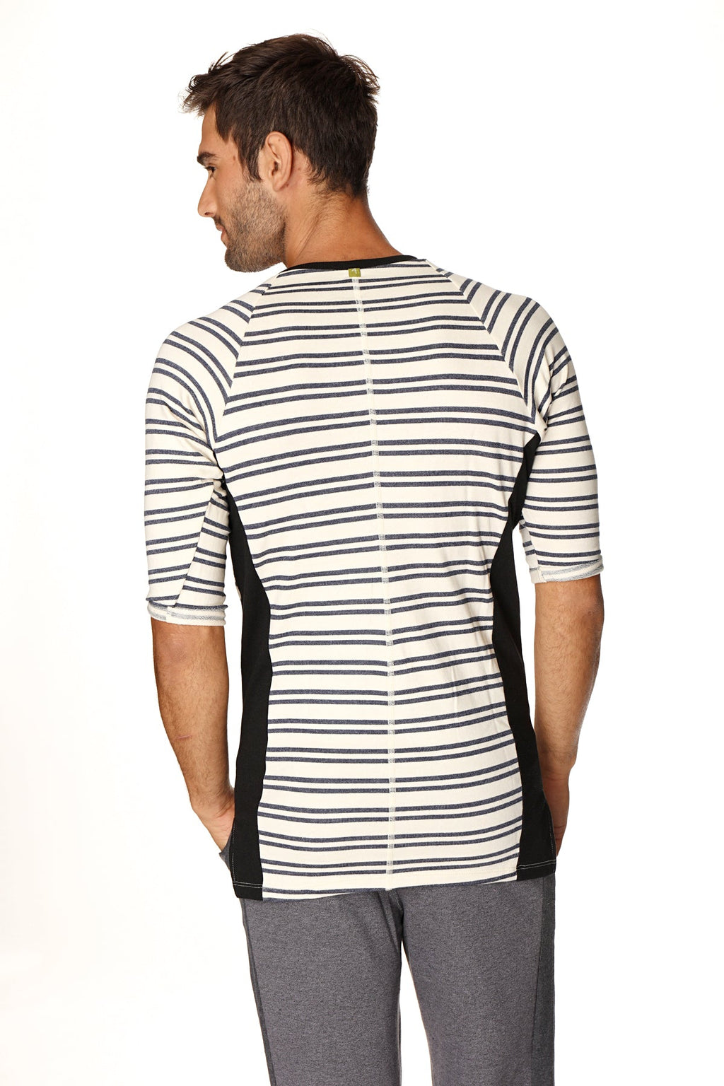 A men’s short-sleeved athletic henley tee in white with black stripes and side panels made of french terry loop