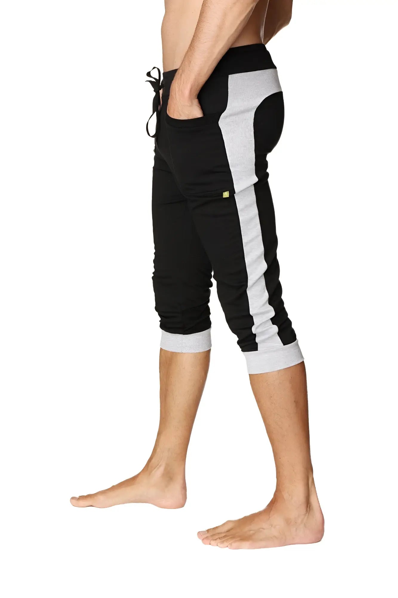 Black and gray cuffed yoga pants with side stripe elastic waistband and rolled cuffs for athletic wear