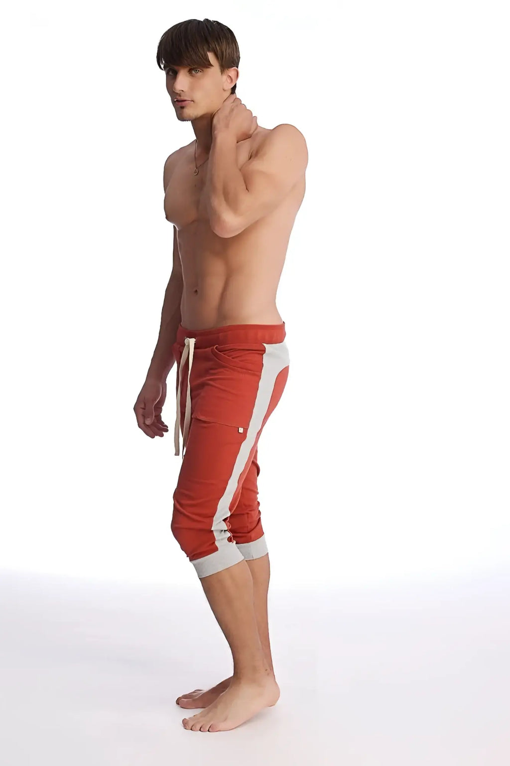 Red cuffed yoga pants with white side stripes and matching drawstring waistband in cinnabar and grey
