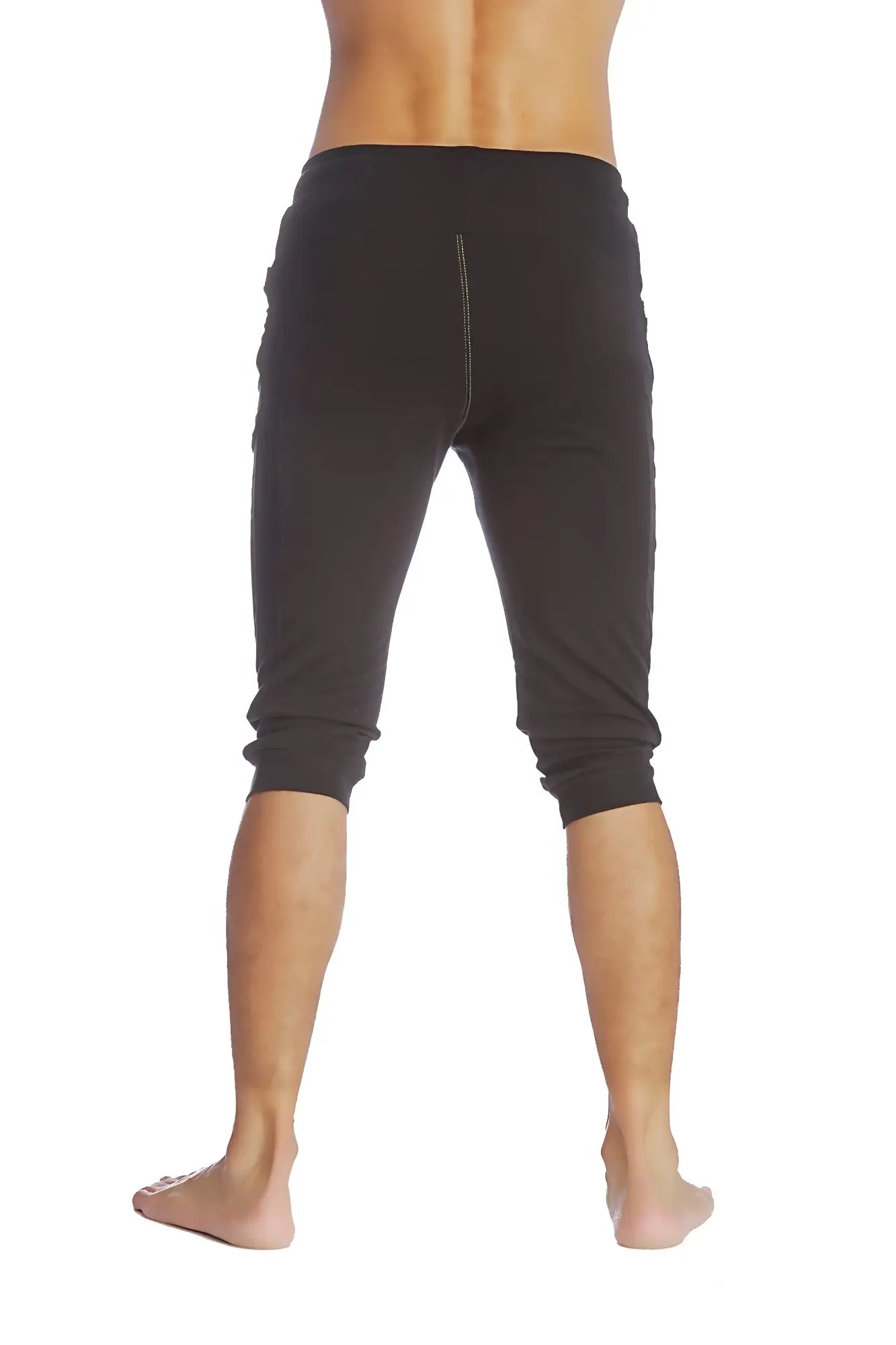Black cuffed yoga pants with a snug fit elastic waistband and capri-length design for athletic wear