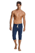 Navy blue cuffed yoga pants in capri length with white drawstring and side pockets for comfortable wear