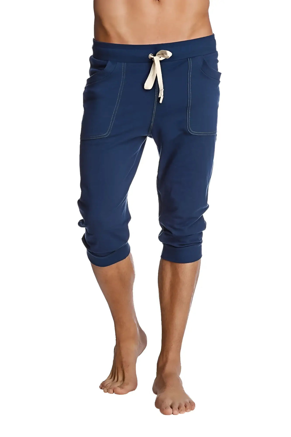 Cuffed yoga pants in solid royal blue with white drawstring and stitched pockets made from navy blue fabric