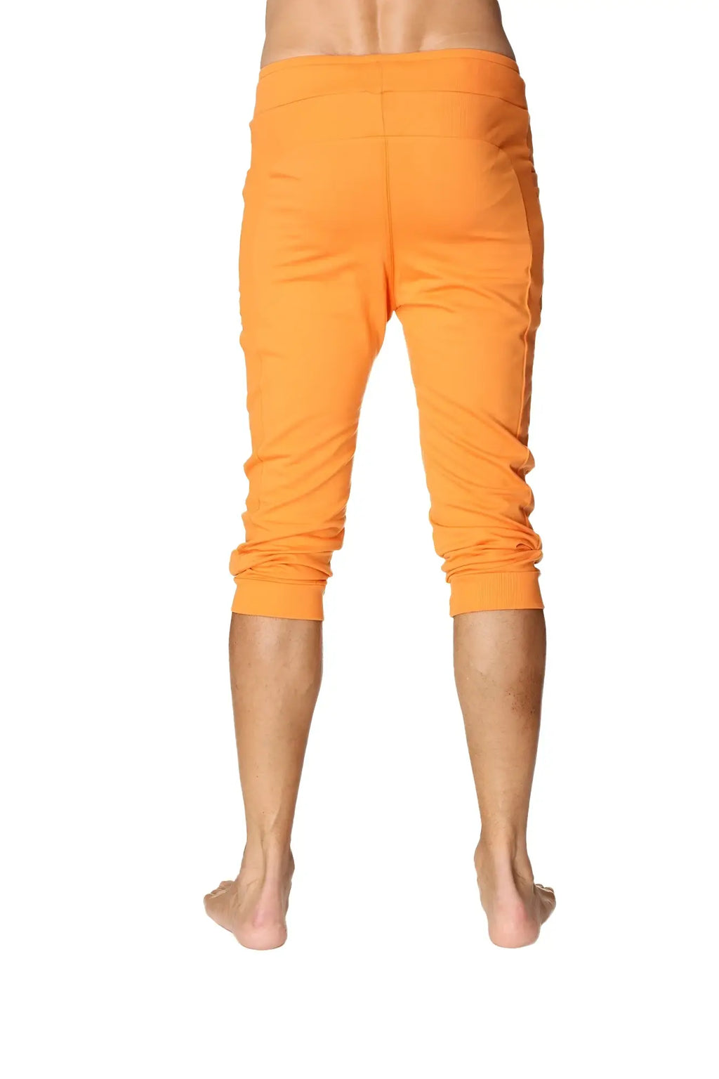 Mens cuffed yoga pants in solid sun orange with bright orange capri-length relaxed fit and elastic waistband