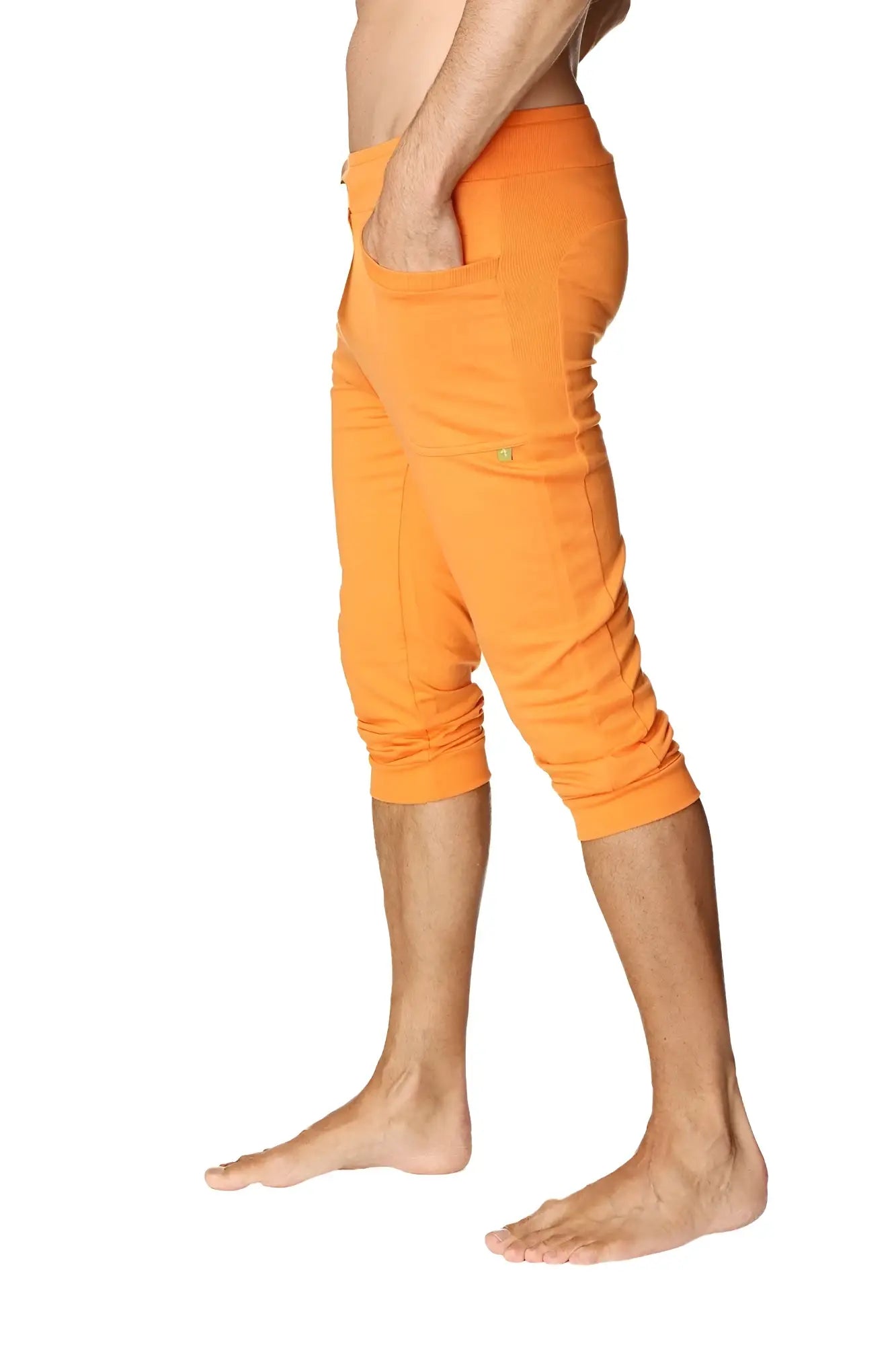 Mens cuffed yoga pants in solid sun orange with relaxed fit and multiple pockets for comfortable activewear