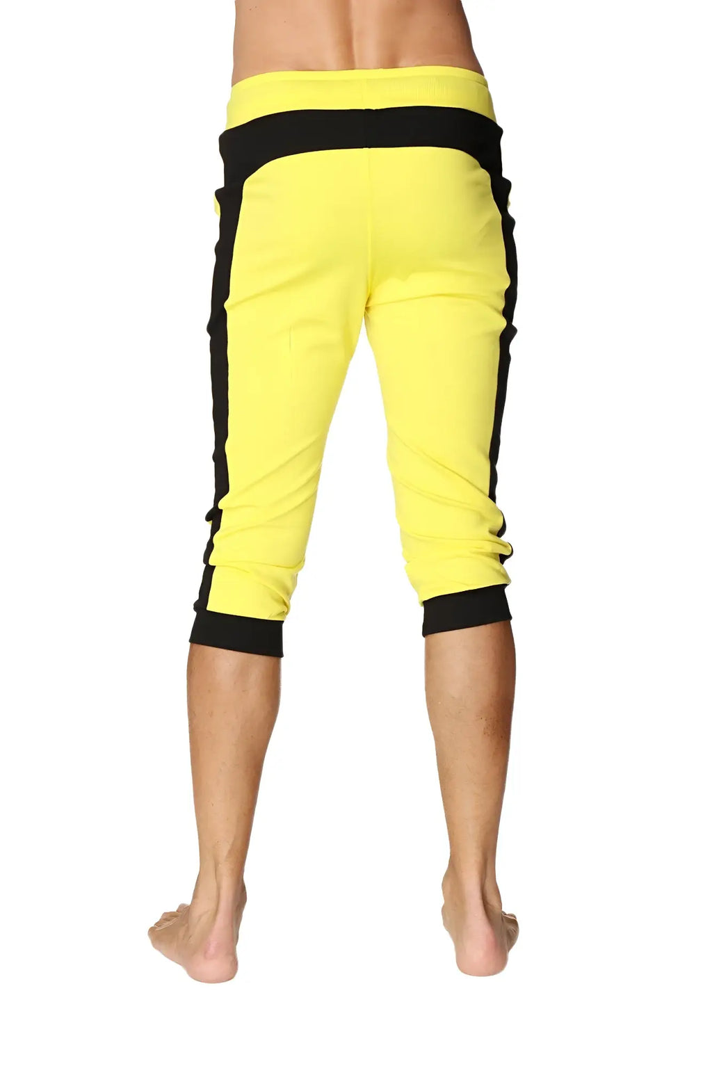 Bright yellow cuffed yoga capri pants with black side stripes and elastic waistband for comfortable wear