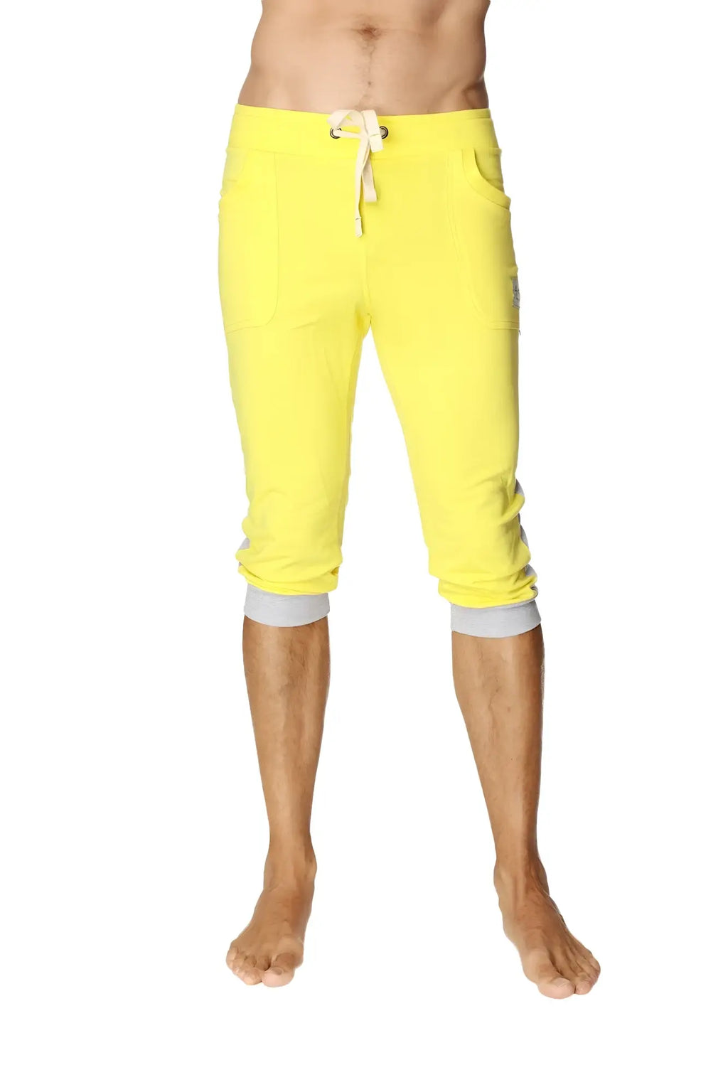 Bright yellow cuffed yoga pants with white drawstring gray elastic cuffs capri length for comfortable workouts