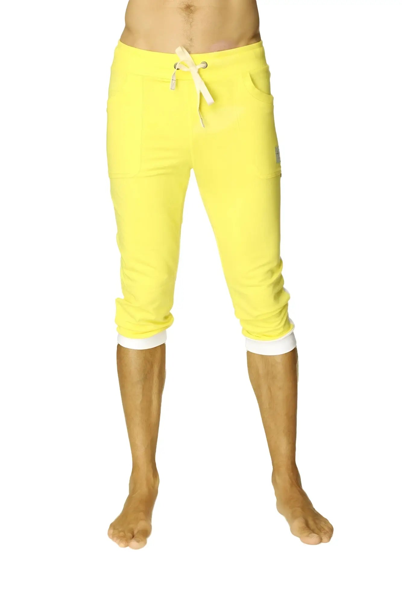 Bright yellow cuffed yoga pants with white drawstring and contrasting white cuffs in capri length for activewear