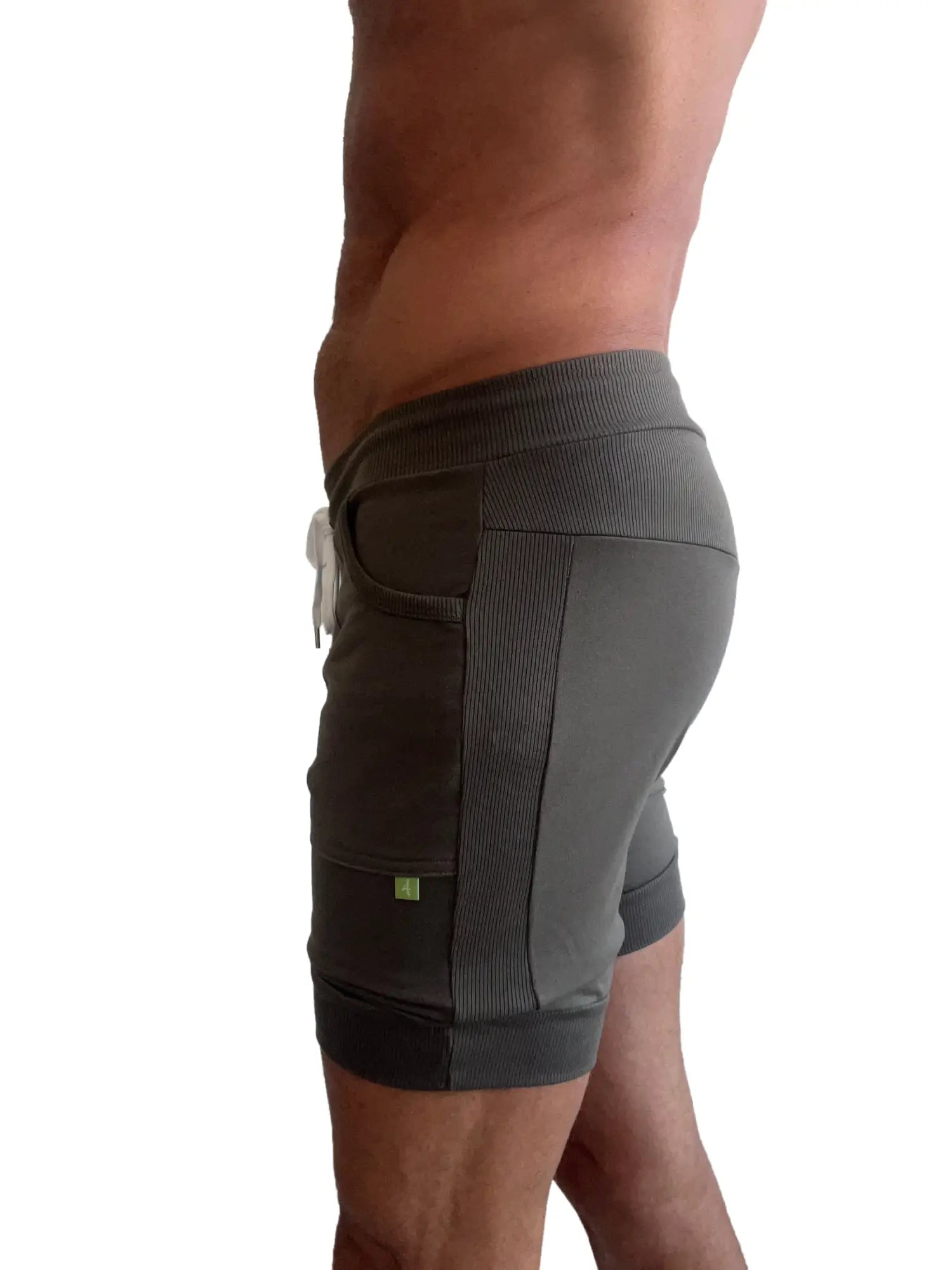 Dark gray cuffed athletic shorts with ribbed side panels and white drawstring designed for yoga and workouts