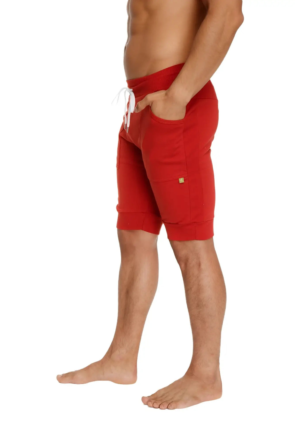 Red cuffed yoga shorts with white drawstring and side pockets made for athletic wear in cinnabar red