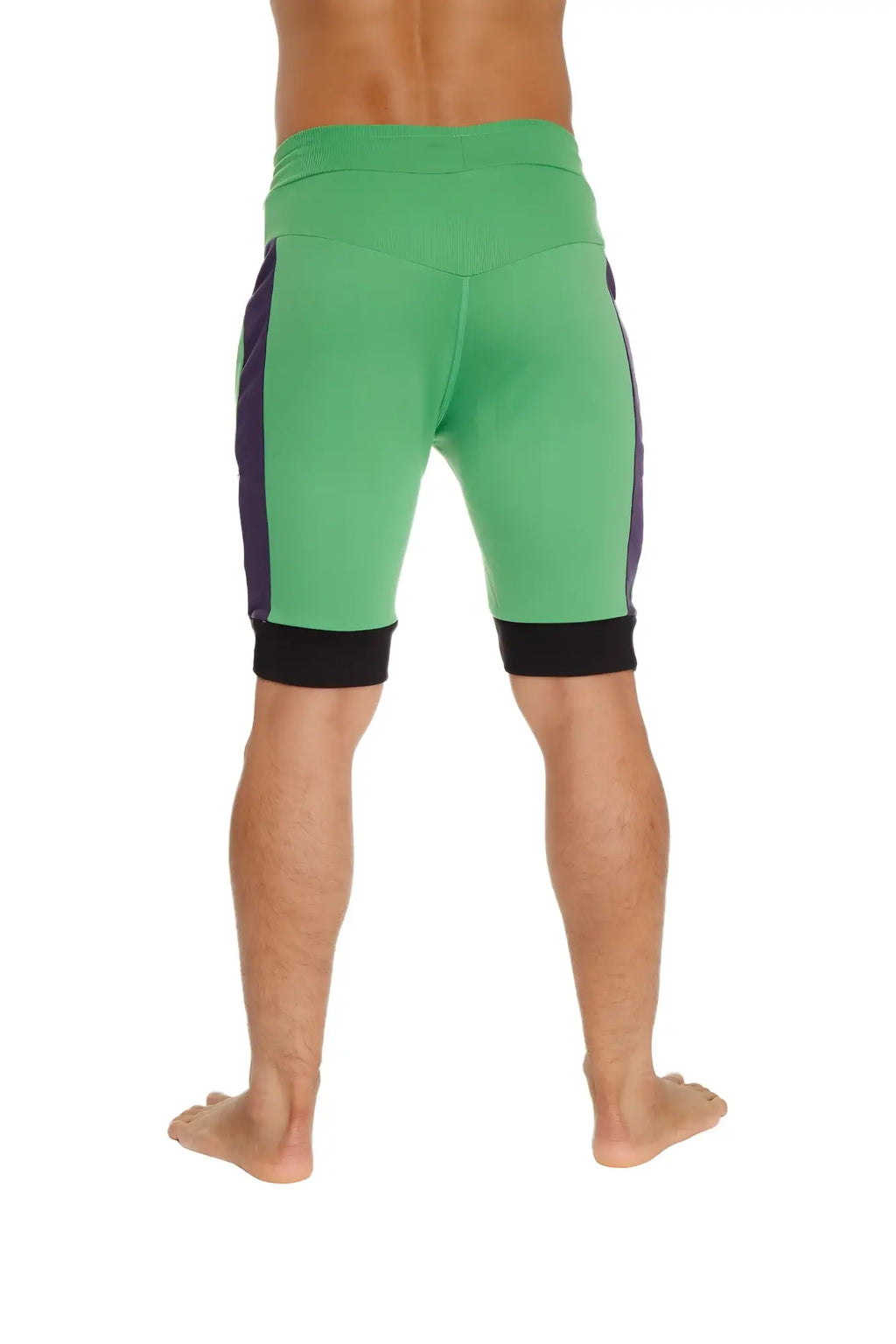 Green cuffed yoga shorts with purple side panels and black waistband and cuff trim for athletic use