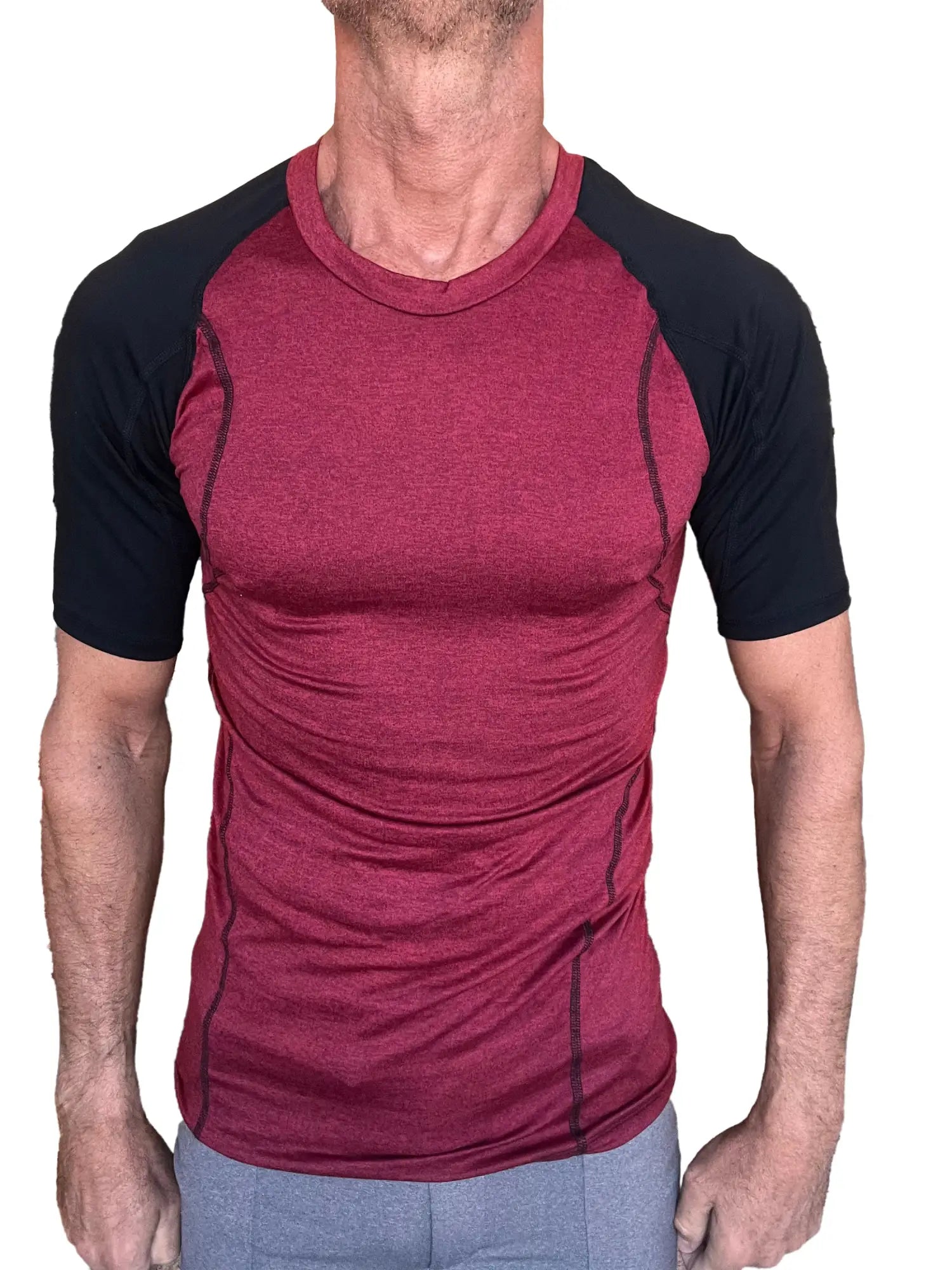 Designer raglan crew-neck tee in brick with black sleeves featuring subtle textured fabric for athletic wear