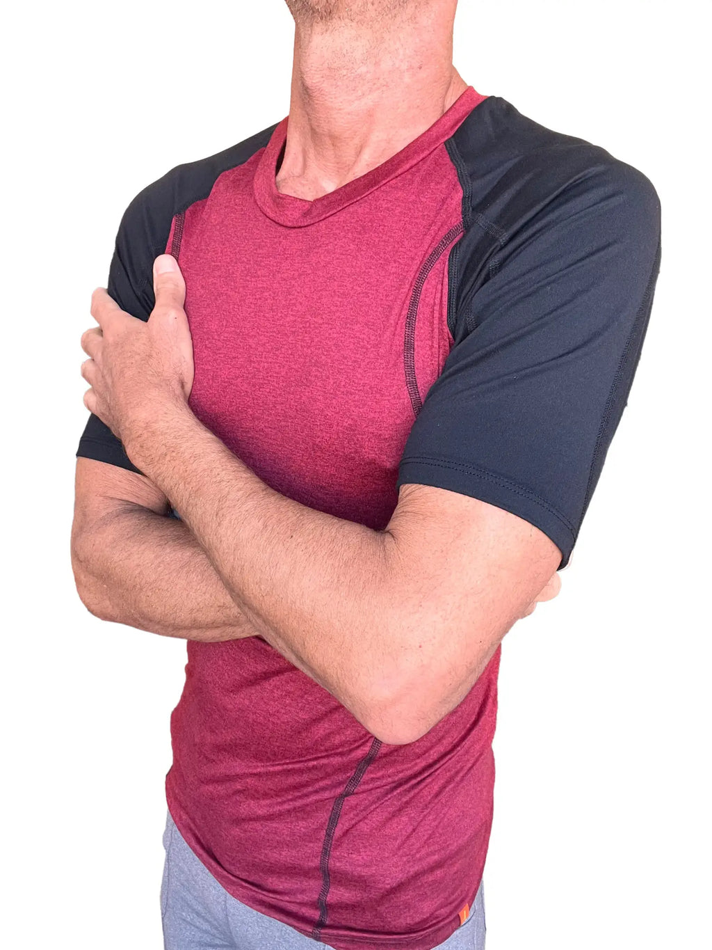 Designer raglan crew-neck tee brick with black sleeves in maroon and black with subtle seam detailing for athletic wear