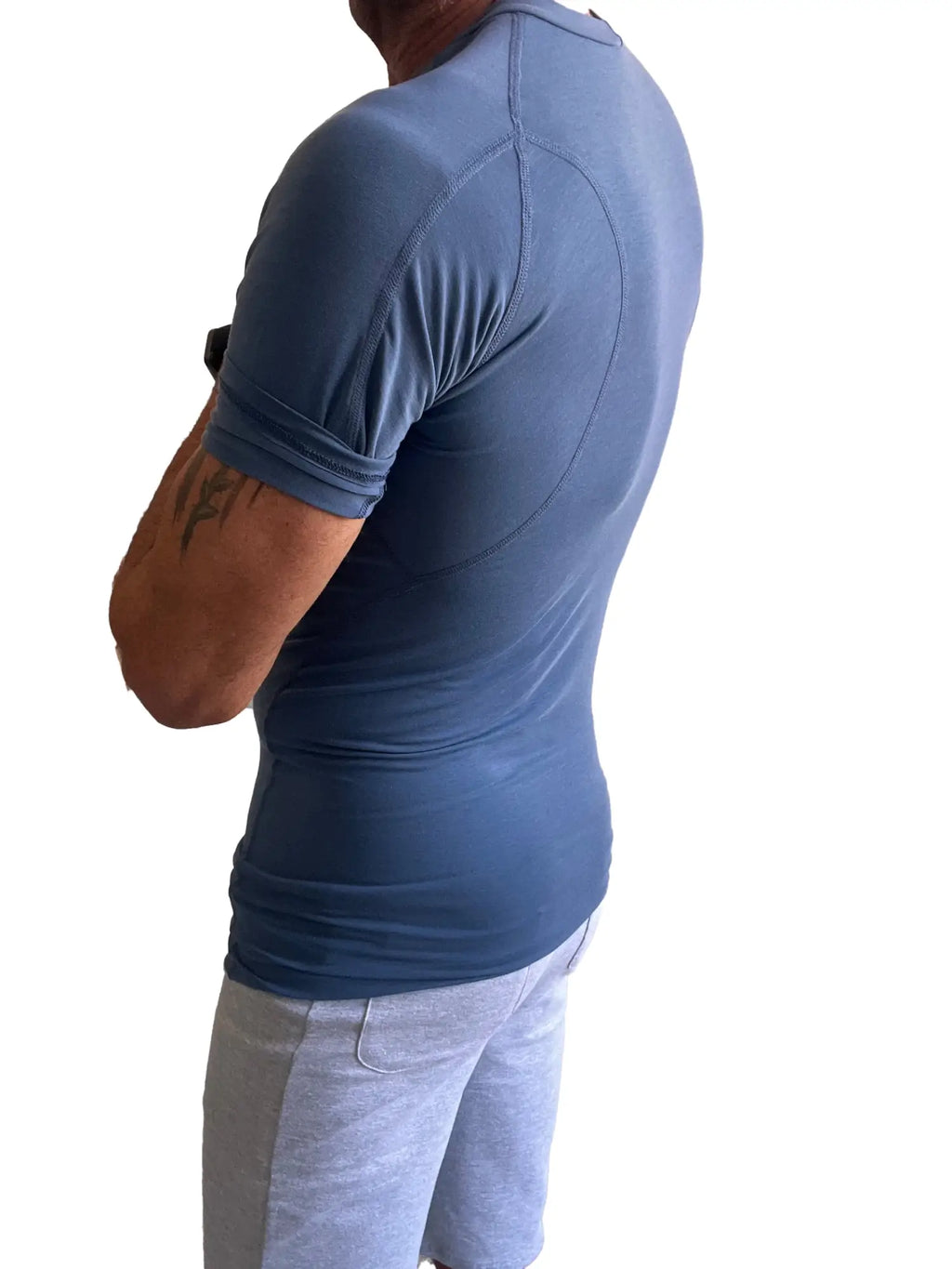 Designer raglan crew neck tee denim blue fitted short sleeved athletic shirt with subtle seams and elasticated cuffs