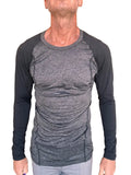 A men’s long-sleeved designer raglan crew-neck tee with heather gray torso and black fitted sleeves for active wear
