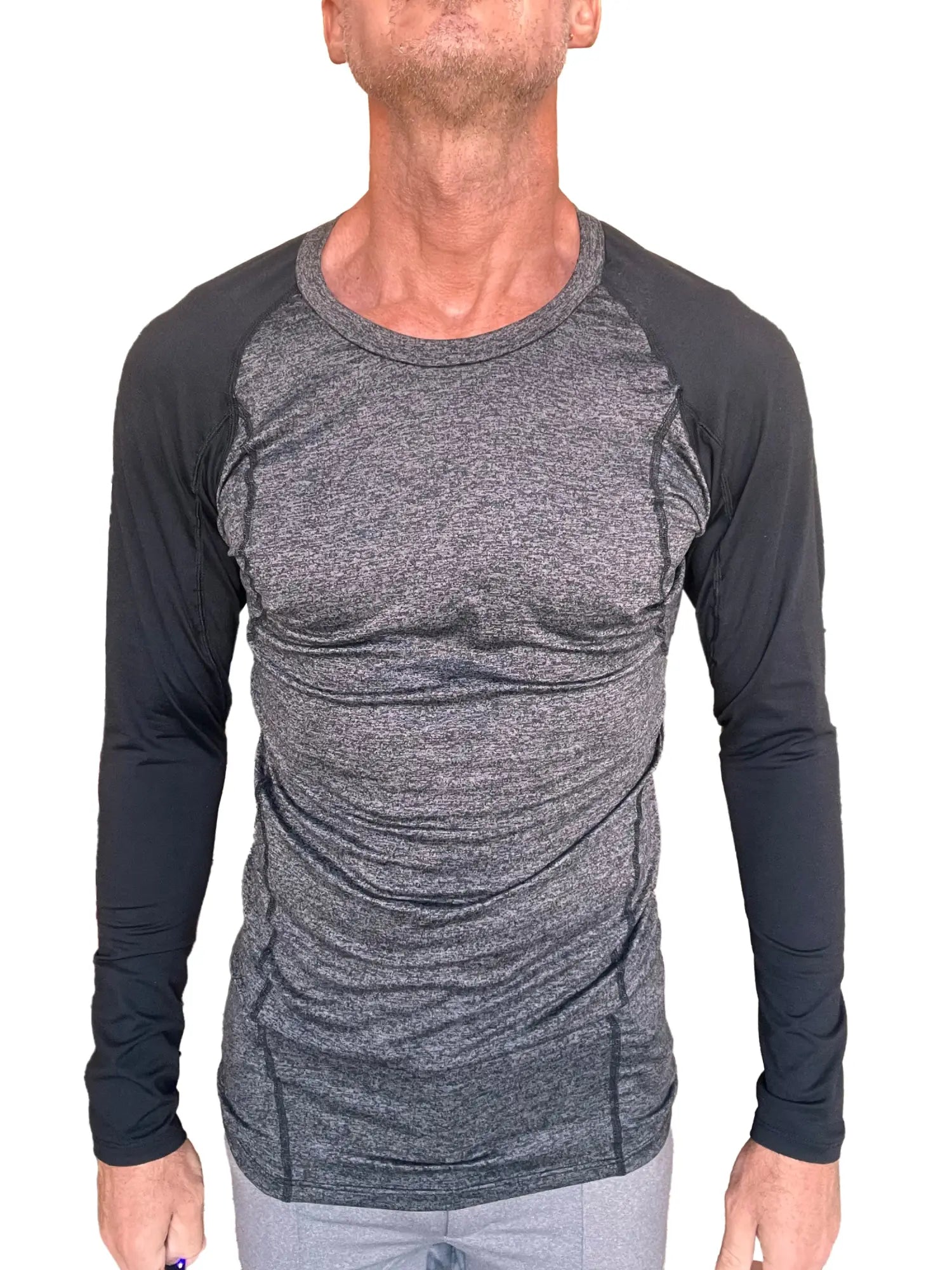 A men’s long-sleeved designer raglan crew-neck tee with heather gray torso and black fitted sleeves for active wear