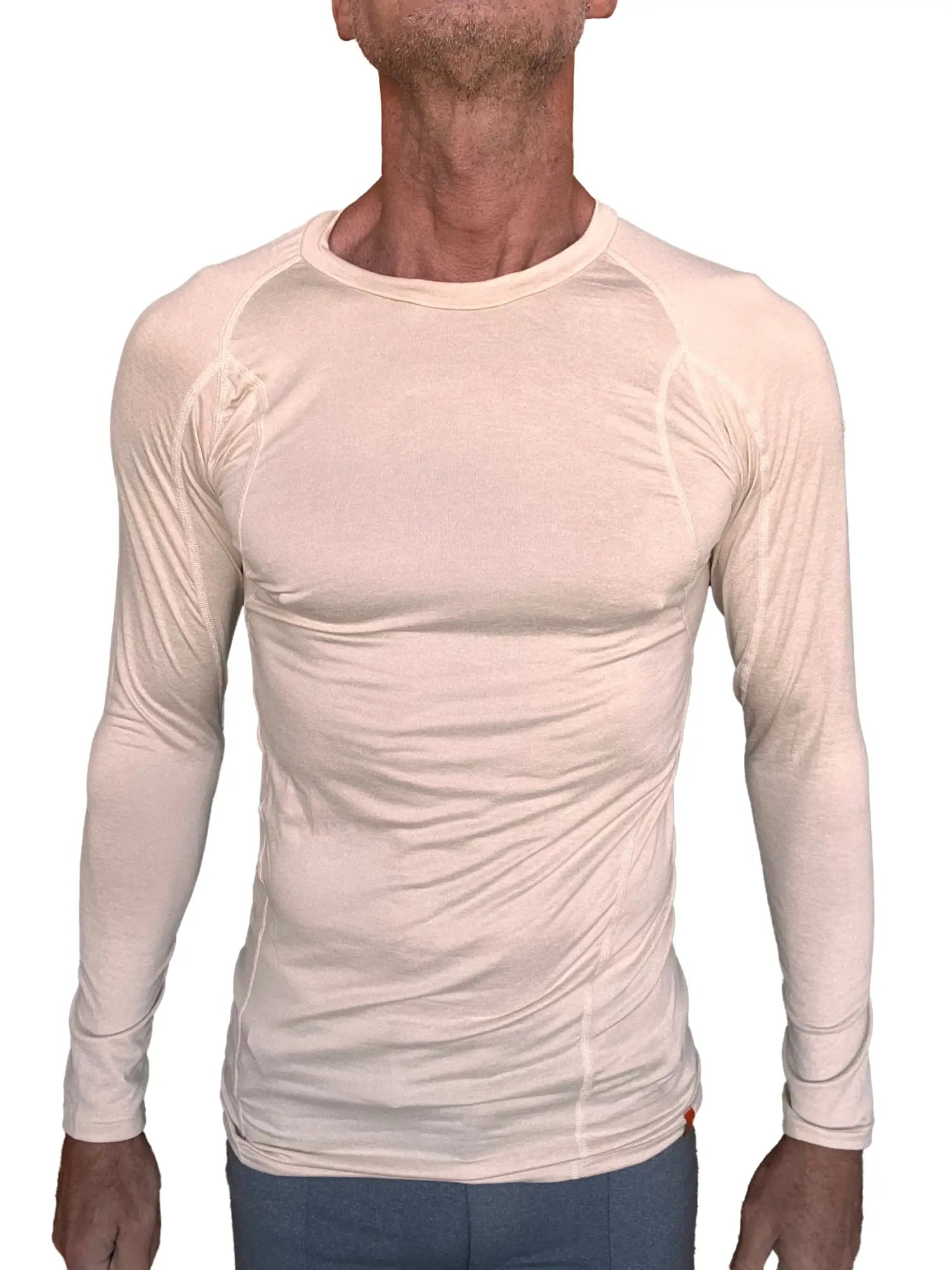 Beige long-sleeved designer raglan crew-neck performance shirt with subtle seam detailing in sand beige color