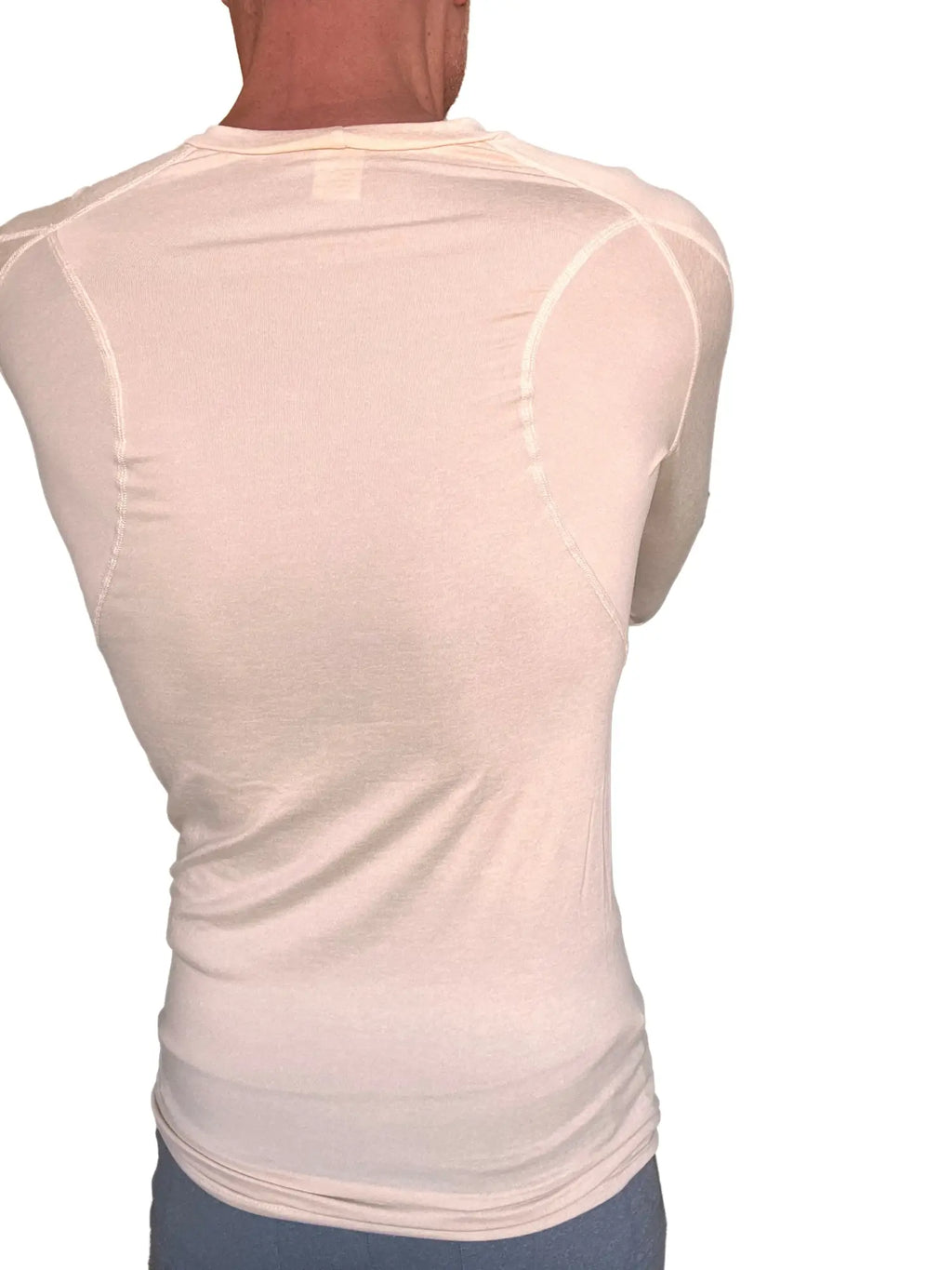A cream-colored sand beige designer raglan crew-neck long sleeve athletic shirt with fitted design and subtle seam detailing