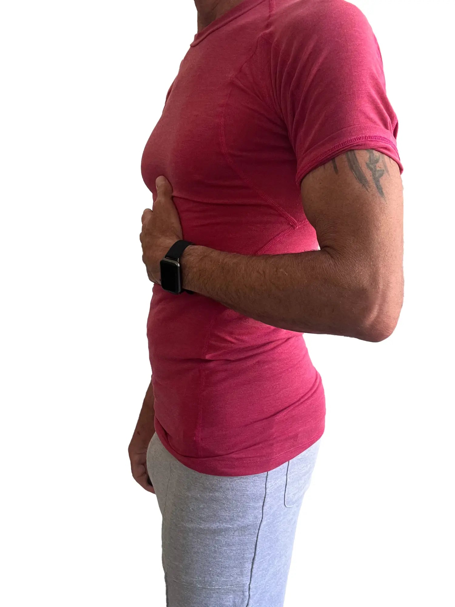 A person wearing a vibrant red raspberry designer raglan crew-neck tee with subtle ribbed texture and short sleeves