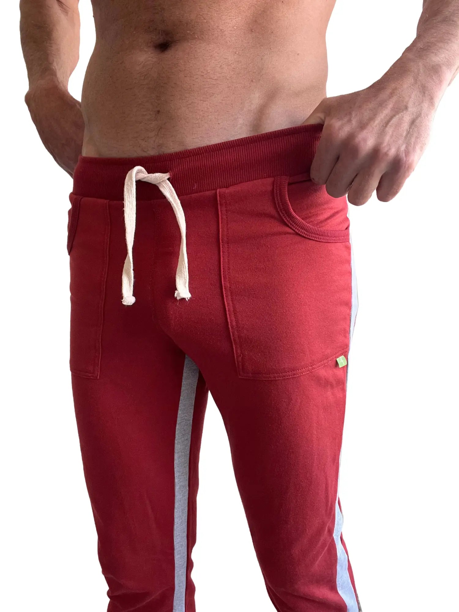 Eco-track and yoga sweat pant in cinnabar red with grey side stripes and white drawstrings designed for athletic wear