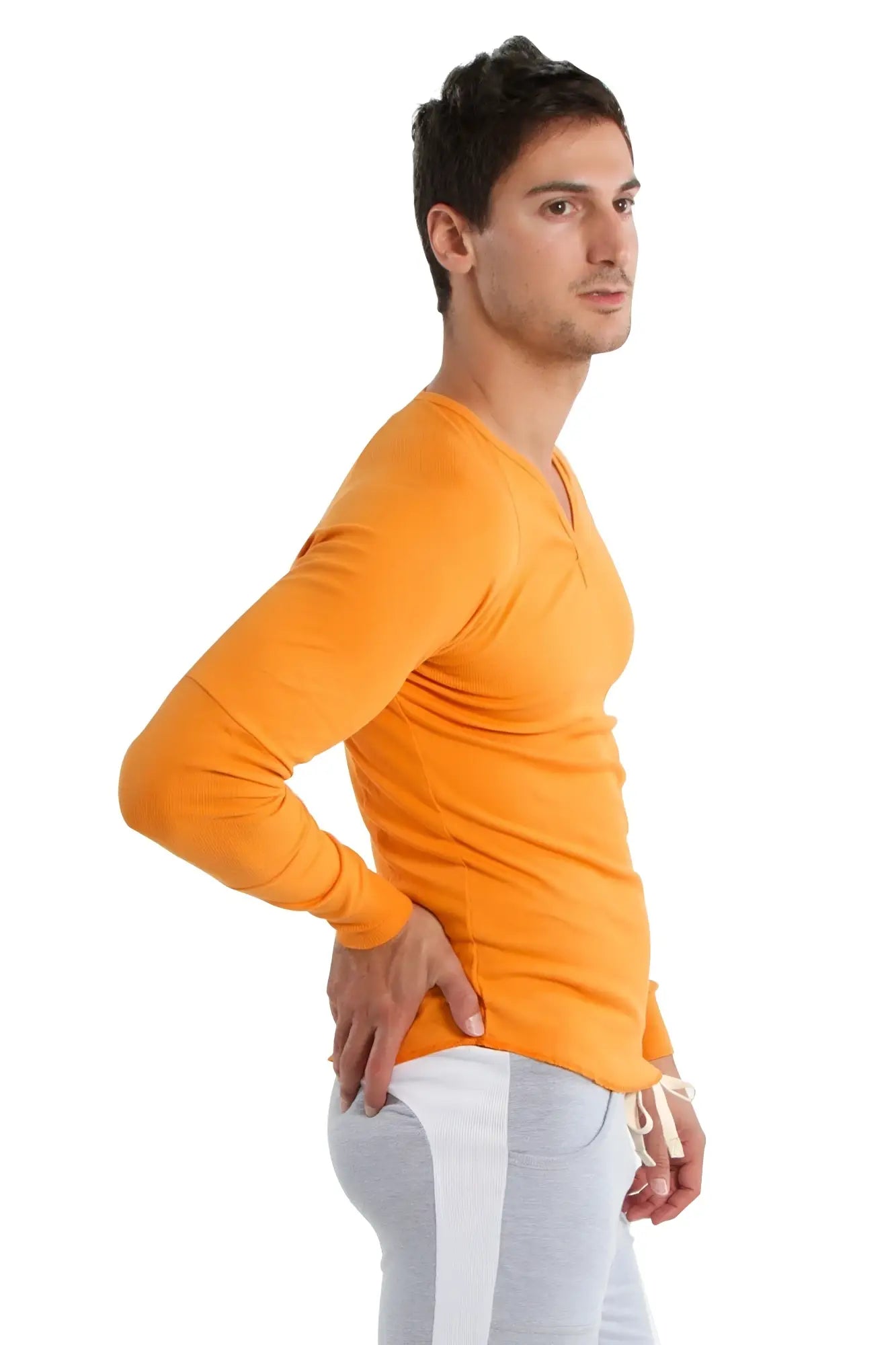 Orange long-sleeved v-neck shirt paired with eco-track and yoga sweat pant in heather grey with white accents