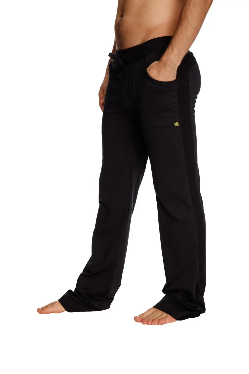 Black eco-track and yoga sweat pant with drawstring waistband and subtle yellow logo on thigh in solid black