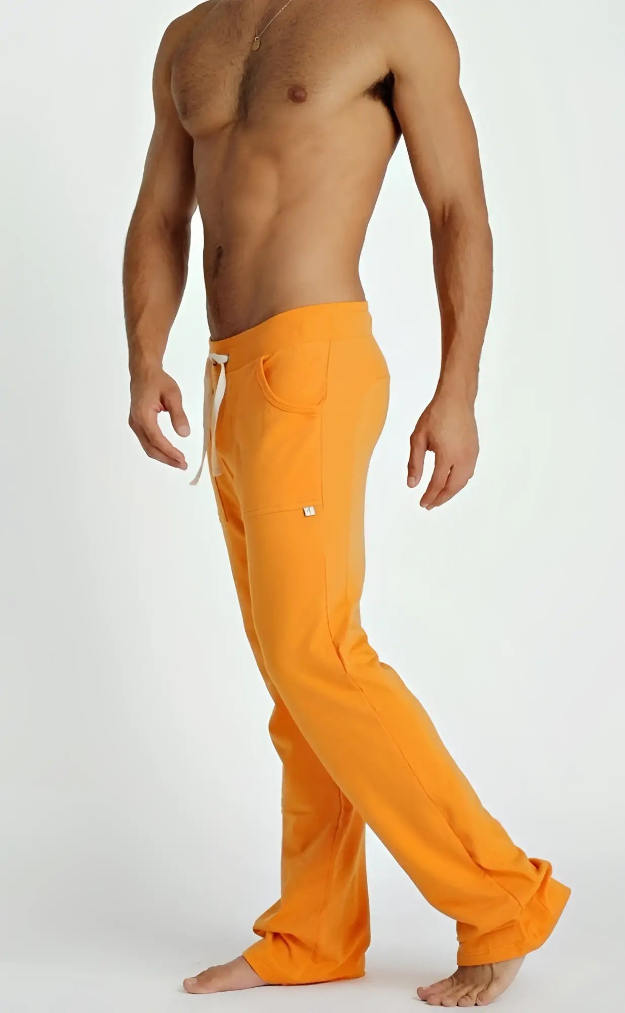 Eco-track & yoga sweat pant in sun orange with white drawstring and side pockets designed for athletic use