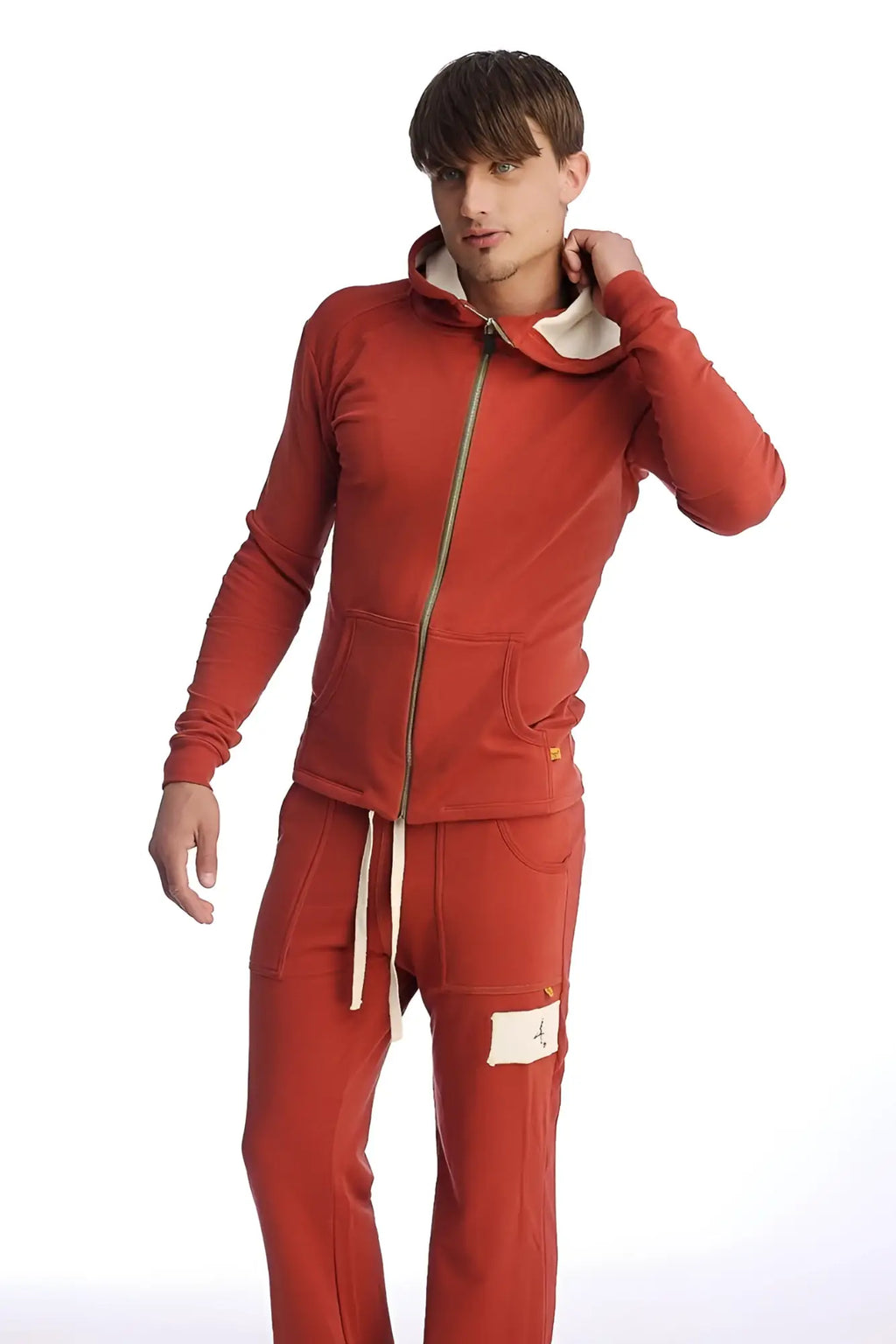 Red hooded sweatshirt with cream inner lining and matching drawstring pants from edge form-fit crossover yoga track performance hoodie cinnabar