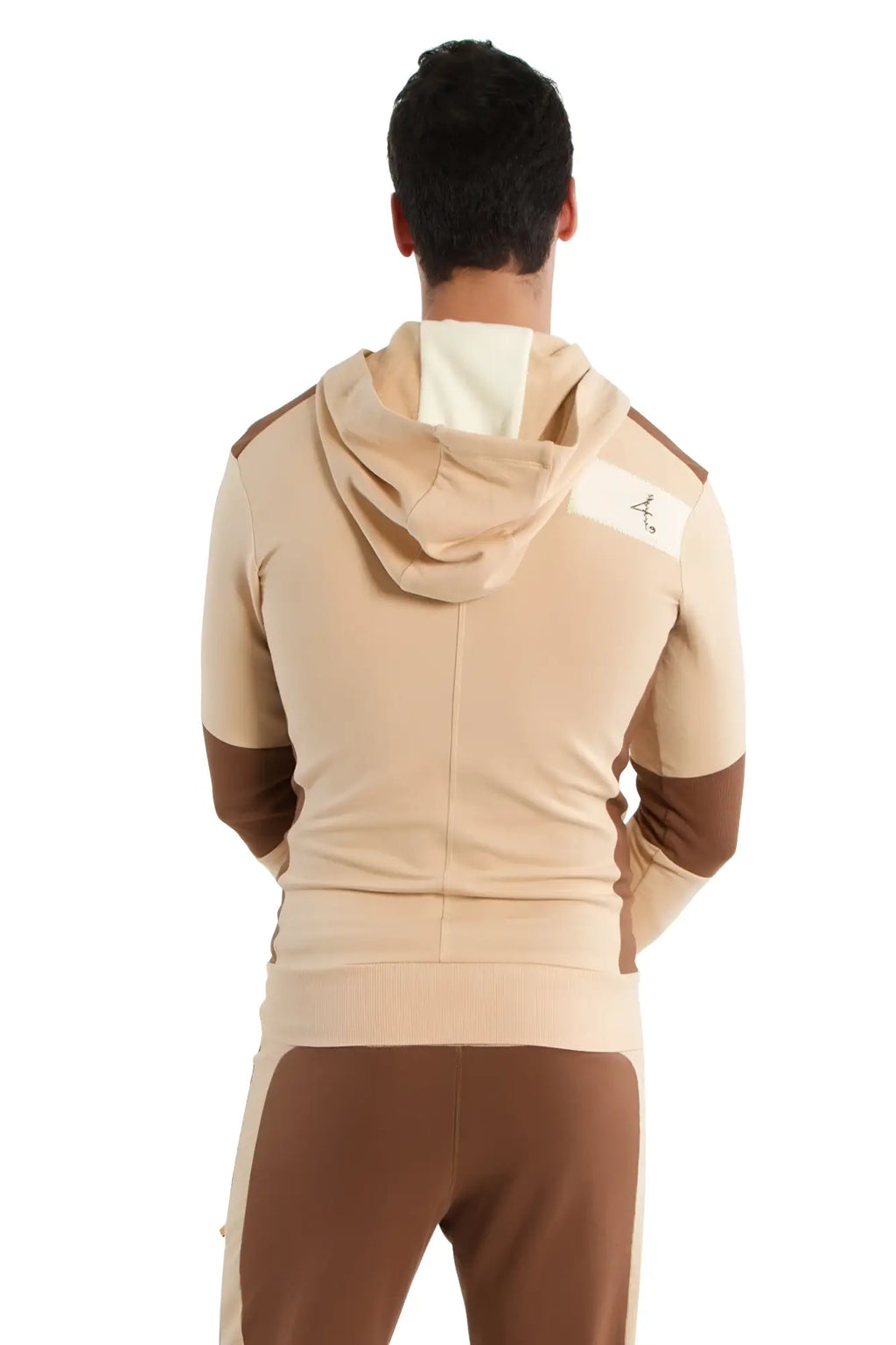 Edge form-fit crossover yoga track performance hoodie in sand and chocolate with a white logo patch on the shoulder