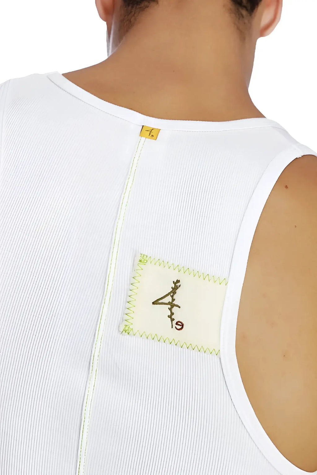 White ribbed sleeveless edge sustain tank top with cream patch featuring black embroidery and lime green zigzag stitching