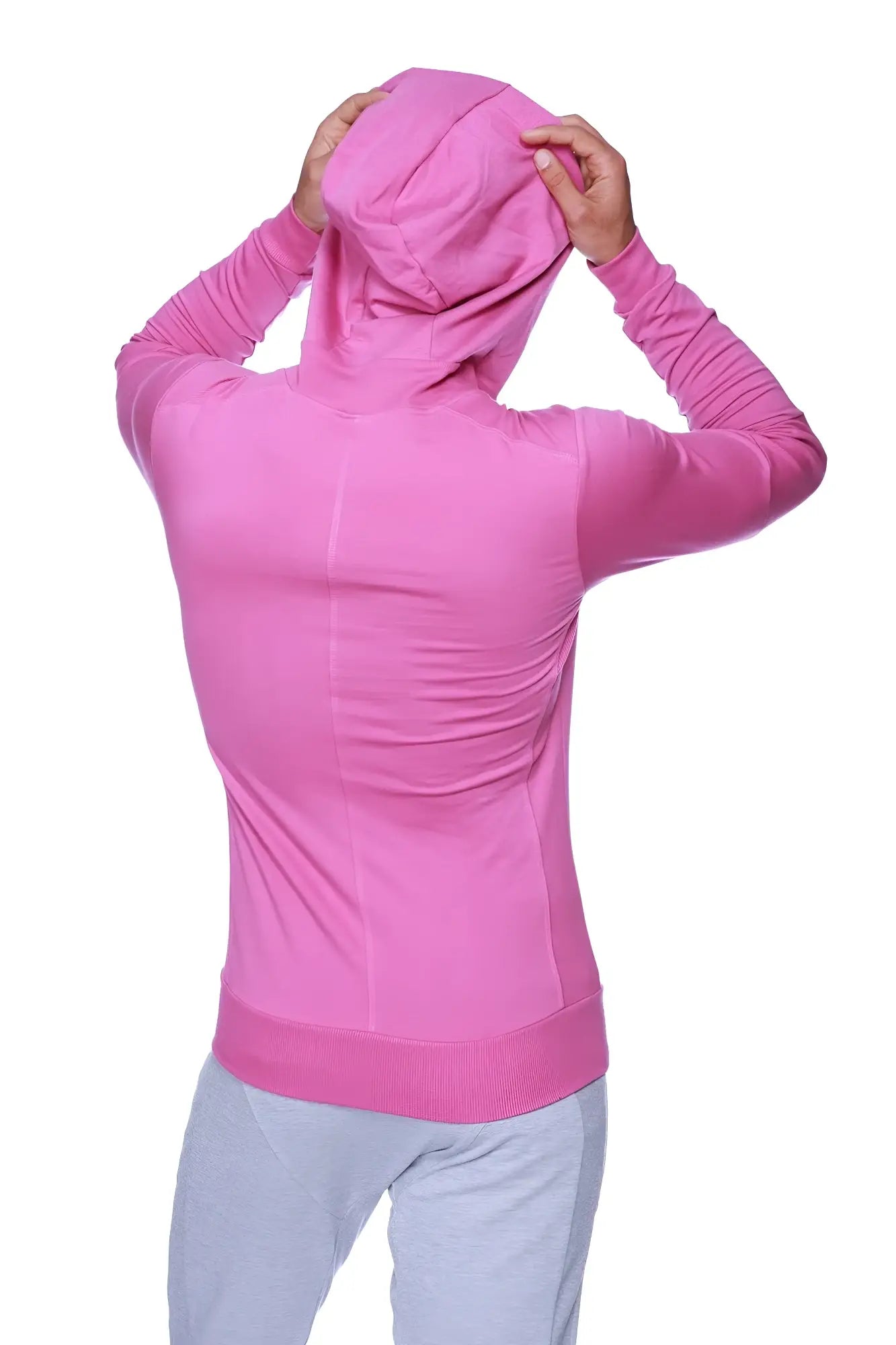 A vibrant pink form-fit crossover yoga track performance hoodie with ribbed cuffs and long sleeves for active wear