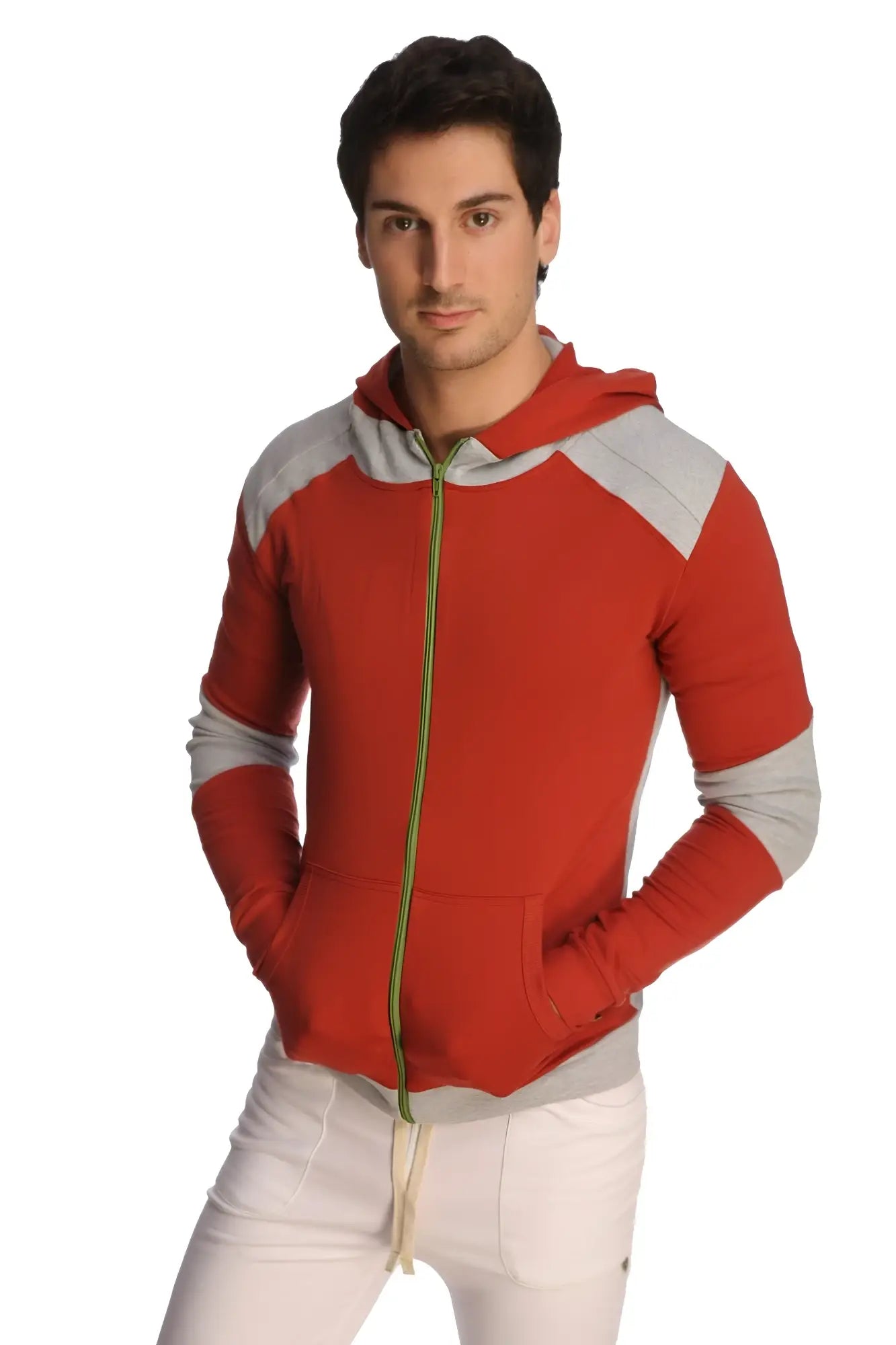 Form-fit crossover yoga track performance hoodie in cinnabar grey with red and gray panels and a green zipper pull