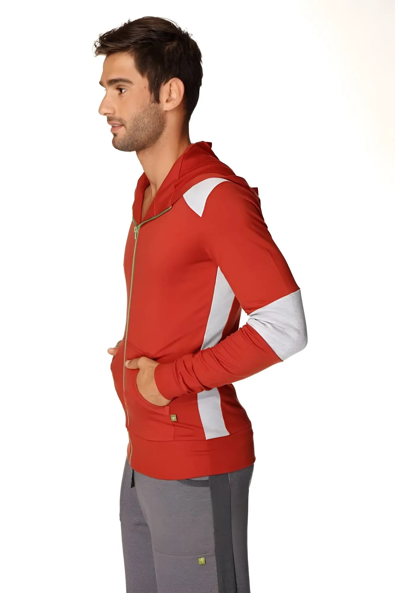 Form-fit crossover yoga track performance hoodie in cinnabar grey features a red zip-up design with white panels and gold zipper