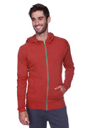 Form-fit crossover yoga track performance hoodie in solid cinnabar red with green zipper and front pockets for activewear
