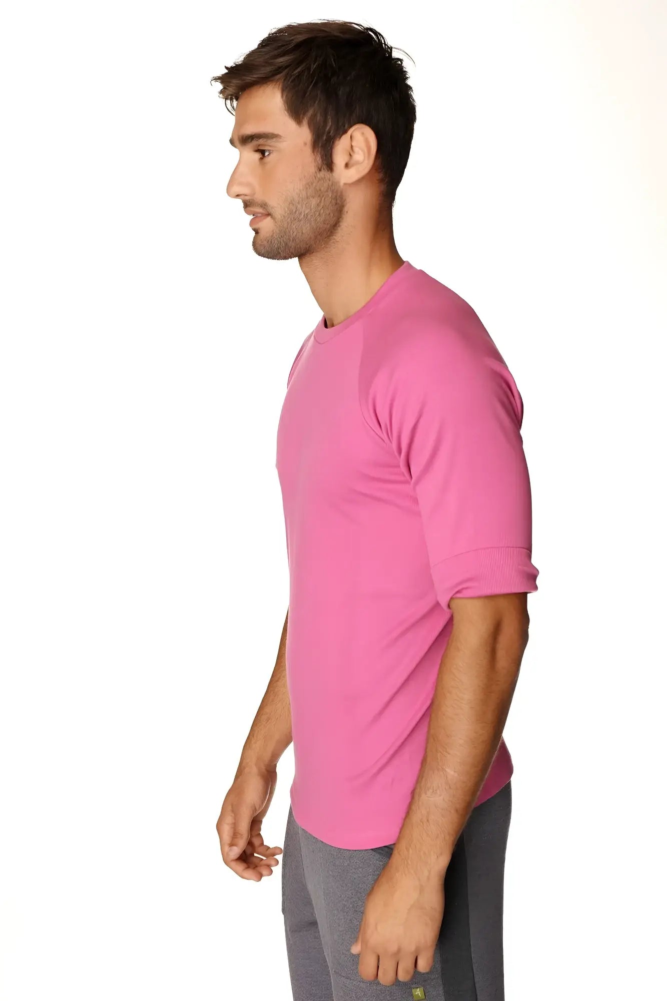 A vibrant pink short-sleeved hybrid crew neck raglan tee with rolled-up sleeves for athletic wear