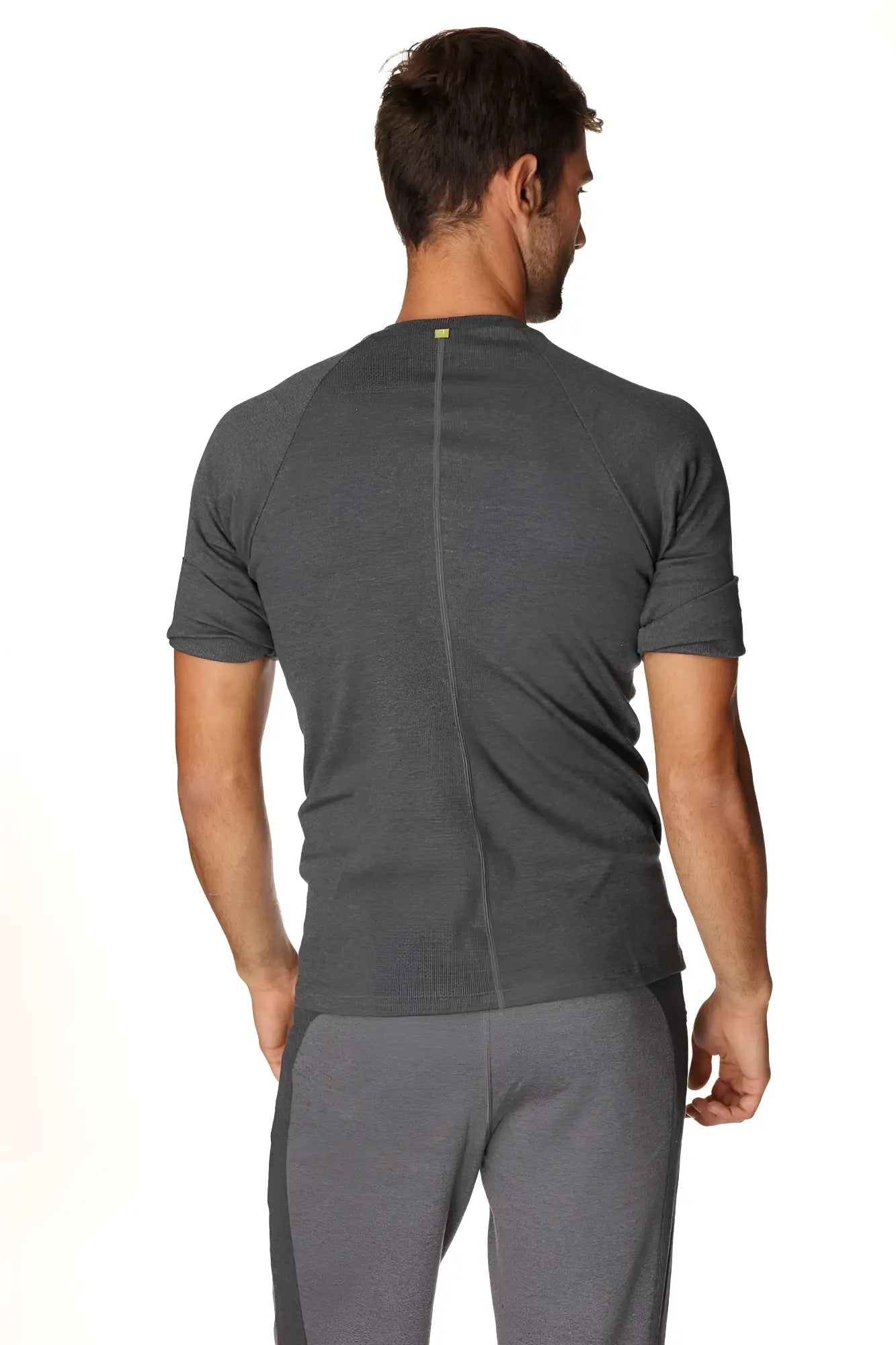 Back view of a dark gray heathered hybrid crew neck raglan tee with a subtle vertical seam ideal for athletic wear