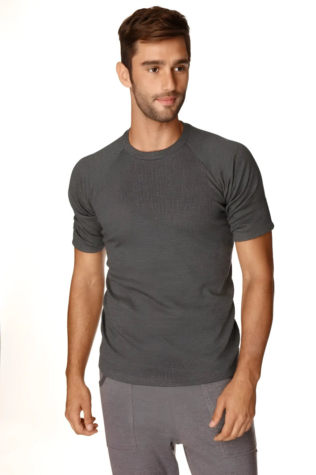 A dark heather gray short-sleeved hybrid crew neck raglan tee made of soft breathable fabric for casual wear