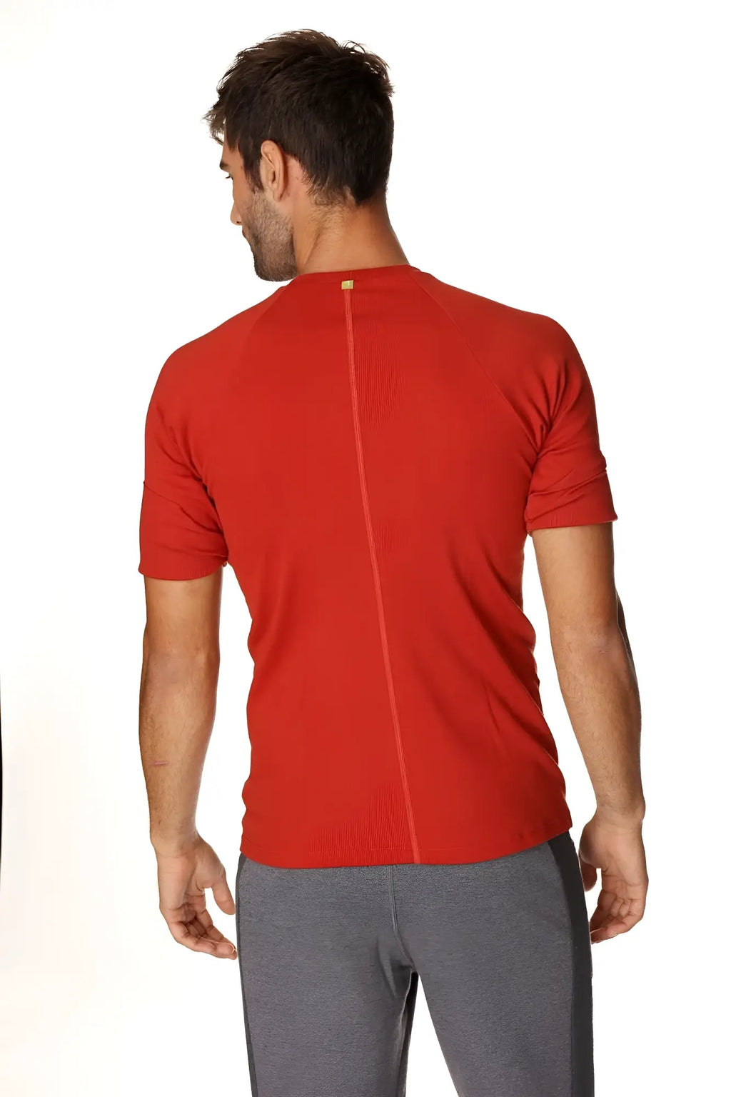 Red short-sleeved hybrid crew neck raglan tee back view with central seam in cinnabar red for athletic use