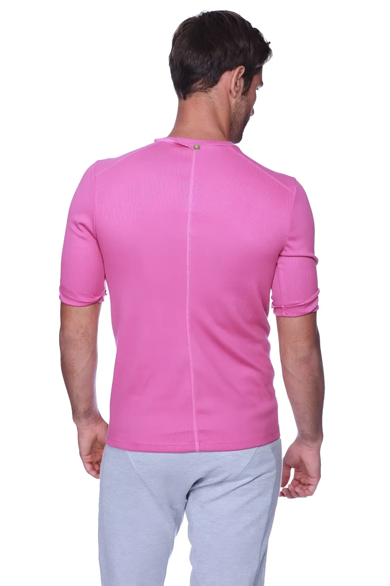 Back view of hybrid v-neck berry short-sleeved athletic shirt in vibrant pink ribbed fabric with vertical seam