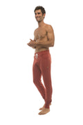 Long cuffed joggers in cinnabar red with white drawstring and side pockets perfect for yoga and athletic wear