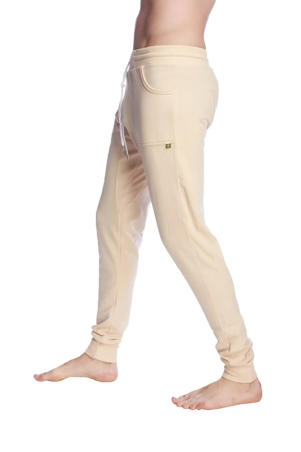 Beige long cuffed jogger and yoga sweat pants with drawstring waistband and elastic cuffs for comfortable wear