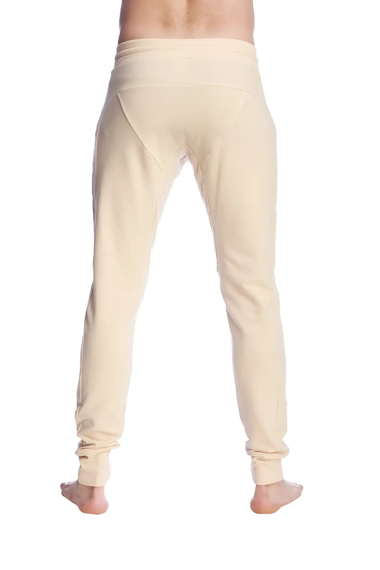 Cream-colored stretchy long cuffed jogger and yoga sweat pants with tapered fit and rolled cuffs in sand beige