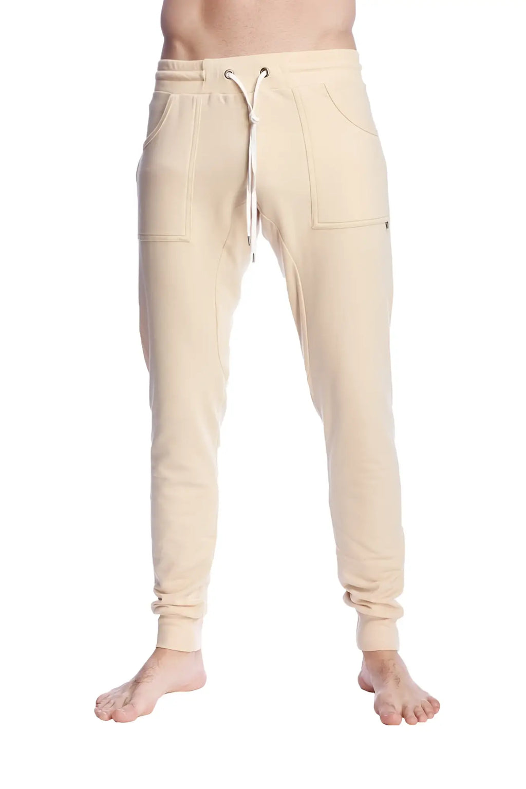 Long cuffed sand beige jogger and yoga sweat pants with drawstring waist and side pockets in cream color