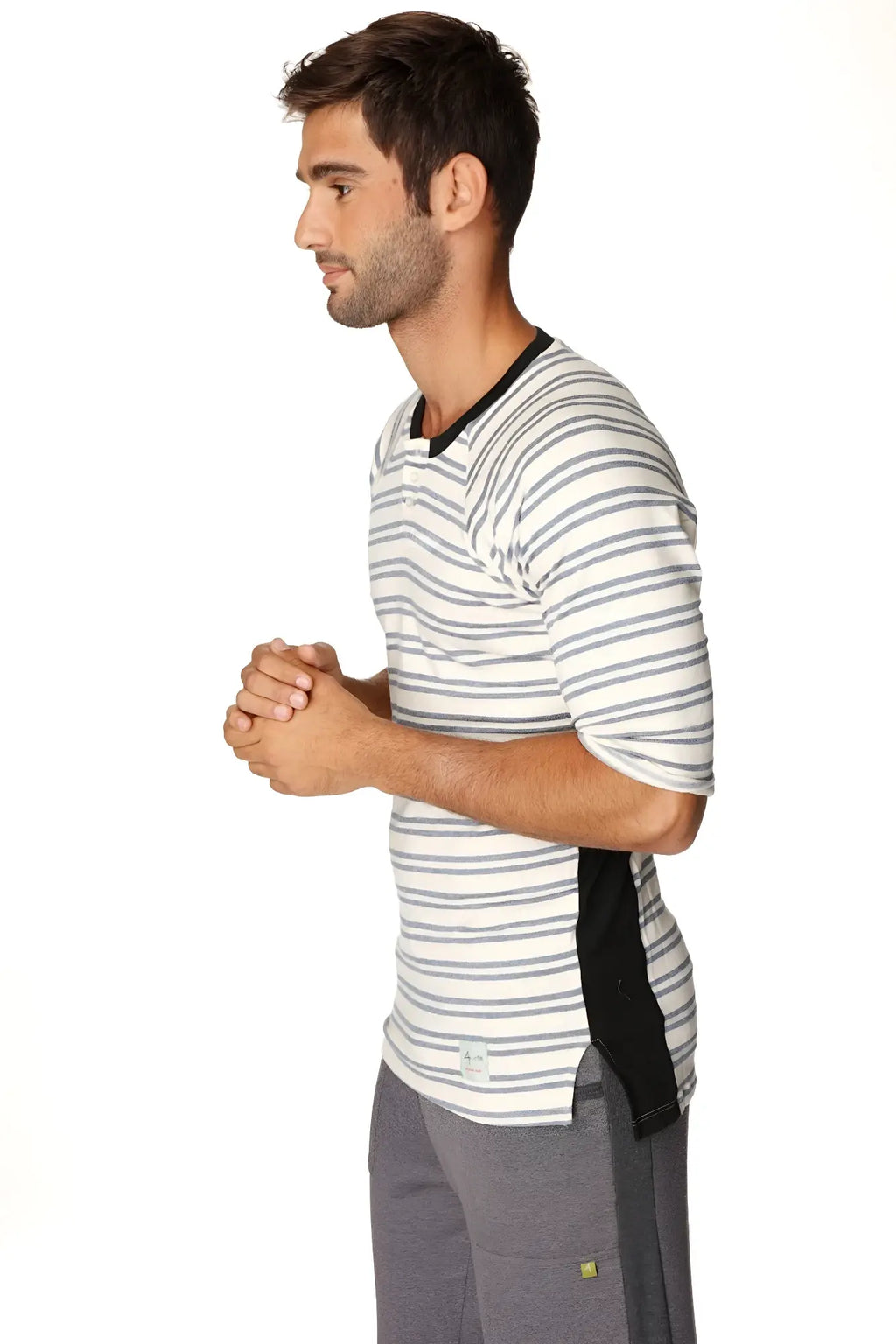 A man wearing a cool blue stripe 4-rth mens vintage-stripe henley tee in french terry loop with black trim