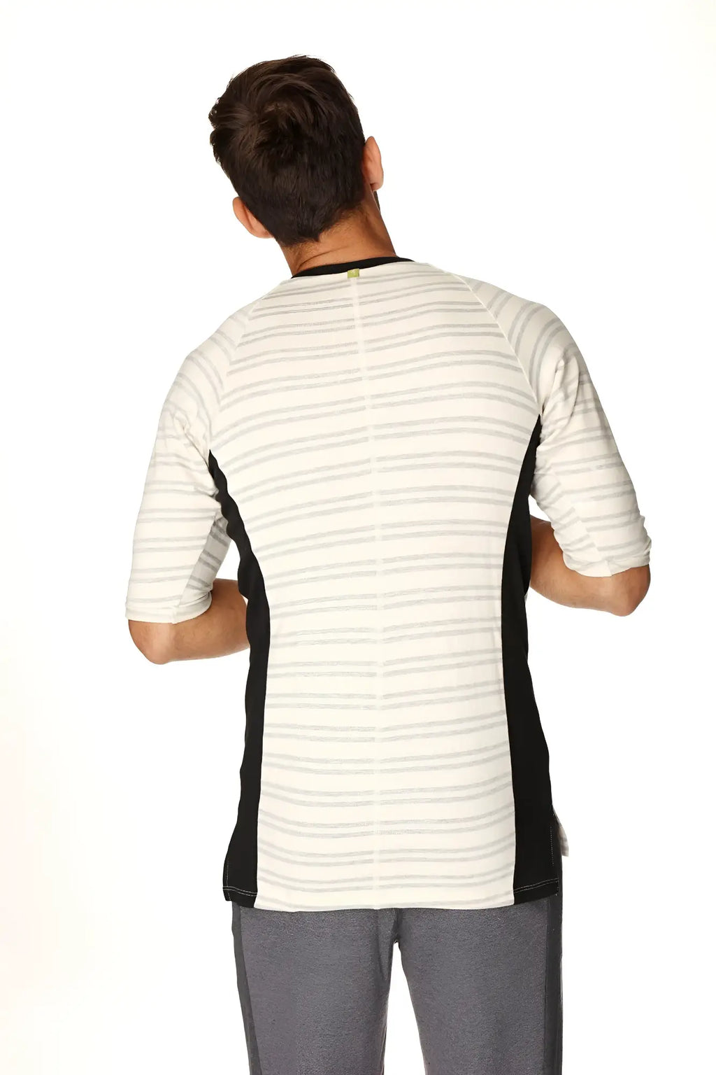 A men’s short-sleeved athletic henley tee in french terry with white base gray stripes and black side panels