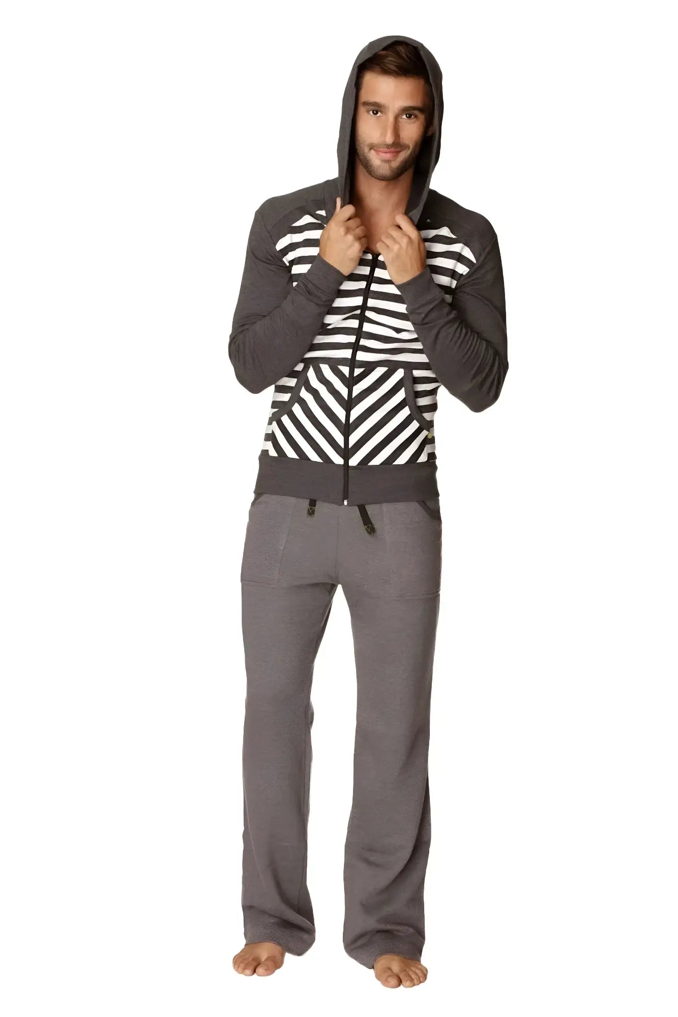 A man wearing a charcoal stripe original limited edition form-fit crossover yoga track performance fleece hoodie with matching pants